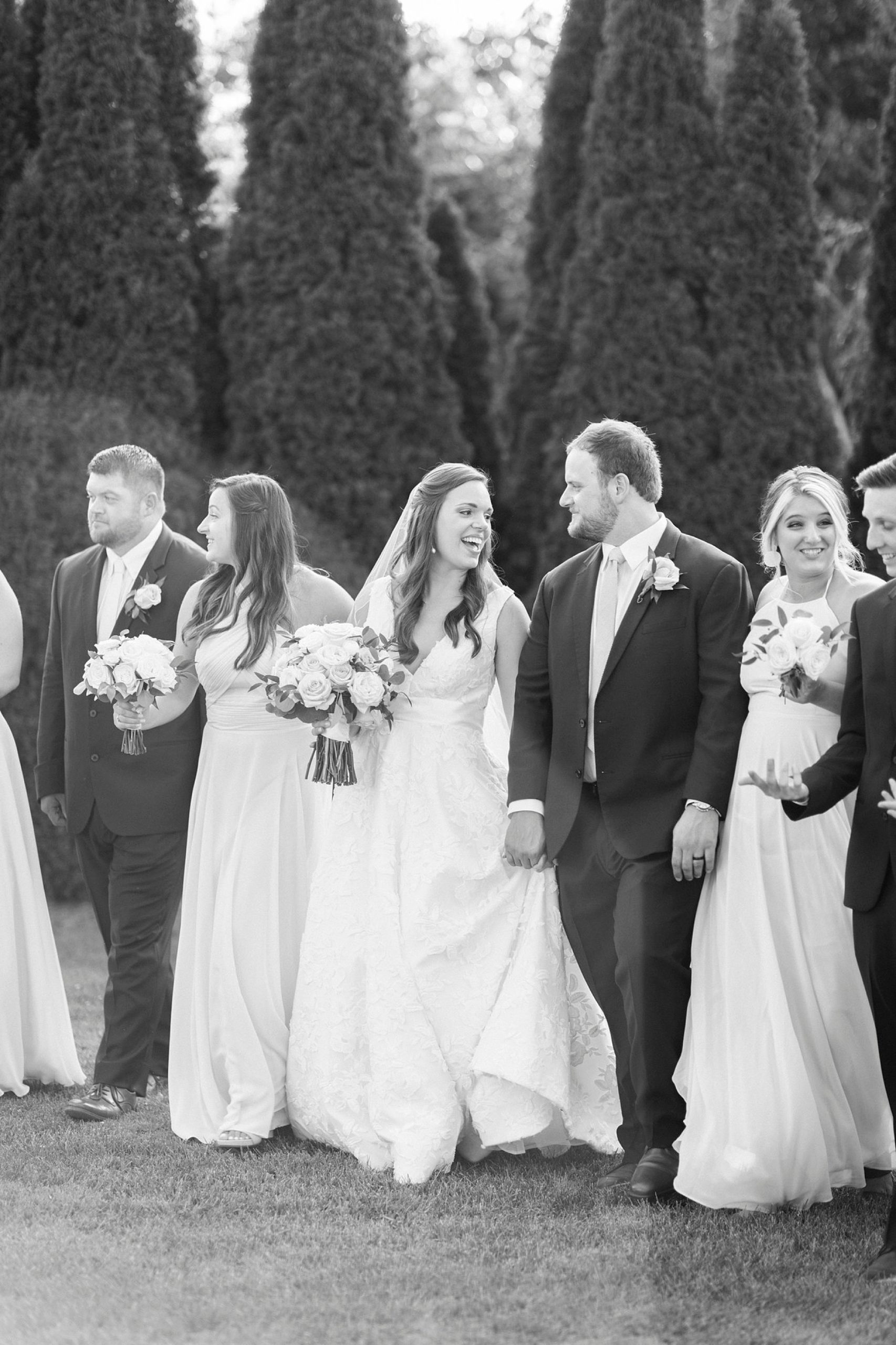 bride and groom walk with wedding party at The Inn at Crestwood wedding