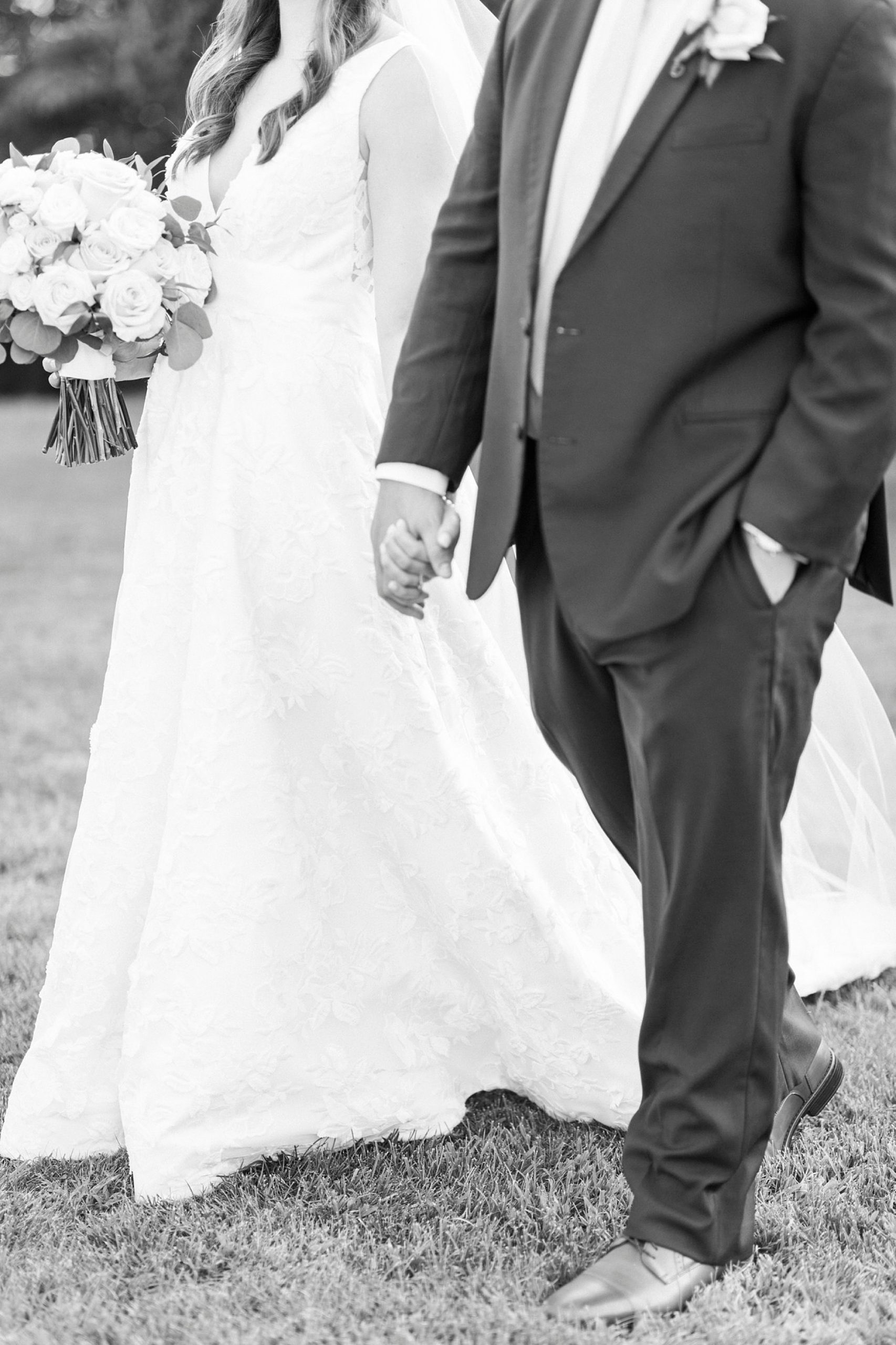 couple holds hands walking during The Inn at Crestwood wedding photos
