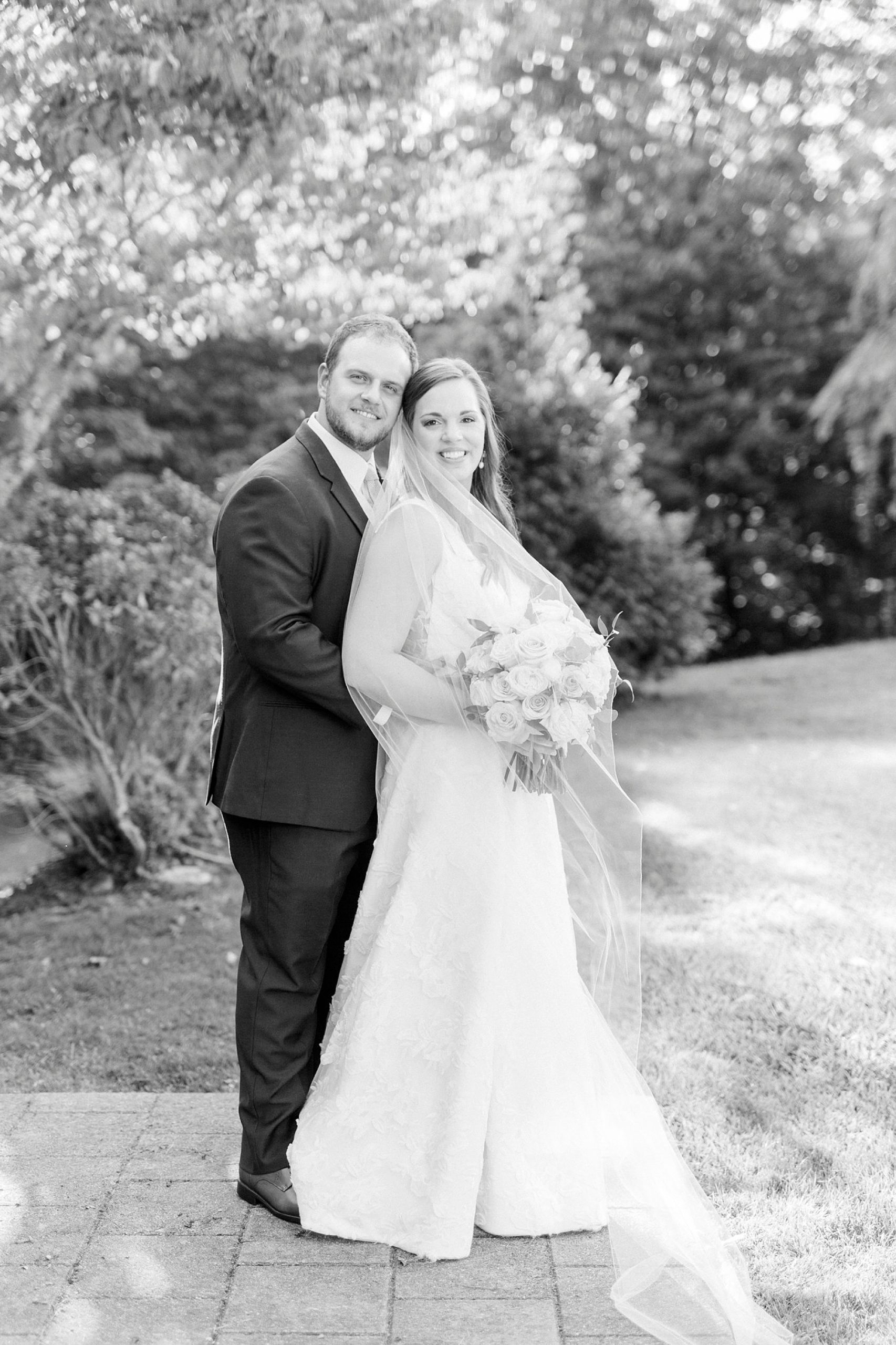 groom hugs bride from behind during NC wedding photos