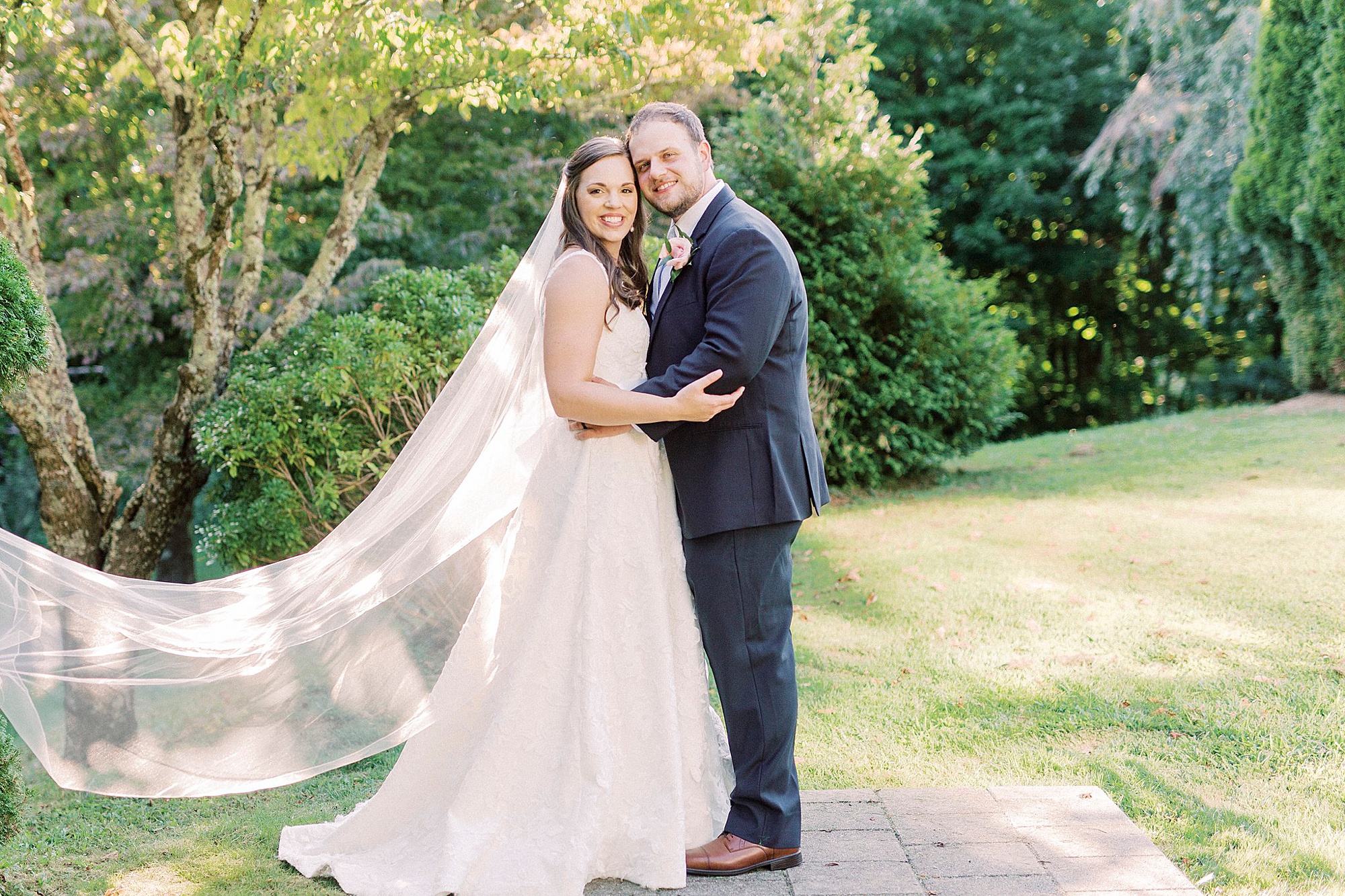 newlyweds hug with their cheeks touching