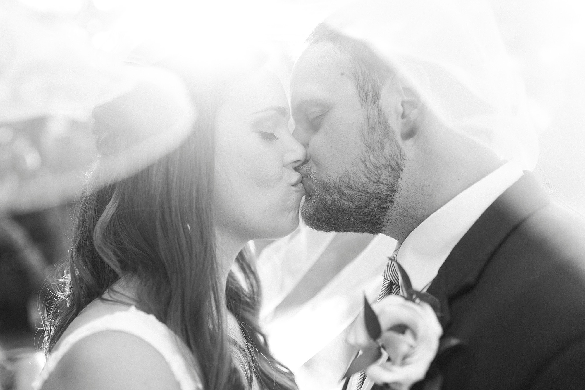 bride and groom kiss under bride's veil at The Inn at Crestwood
