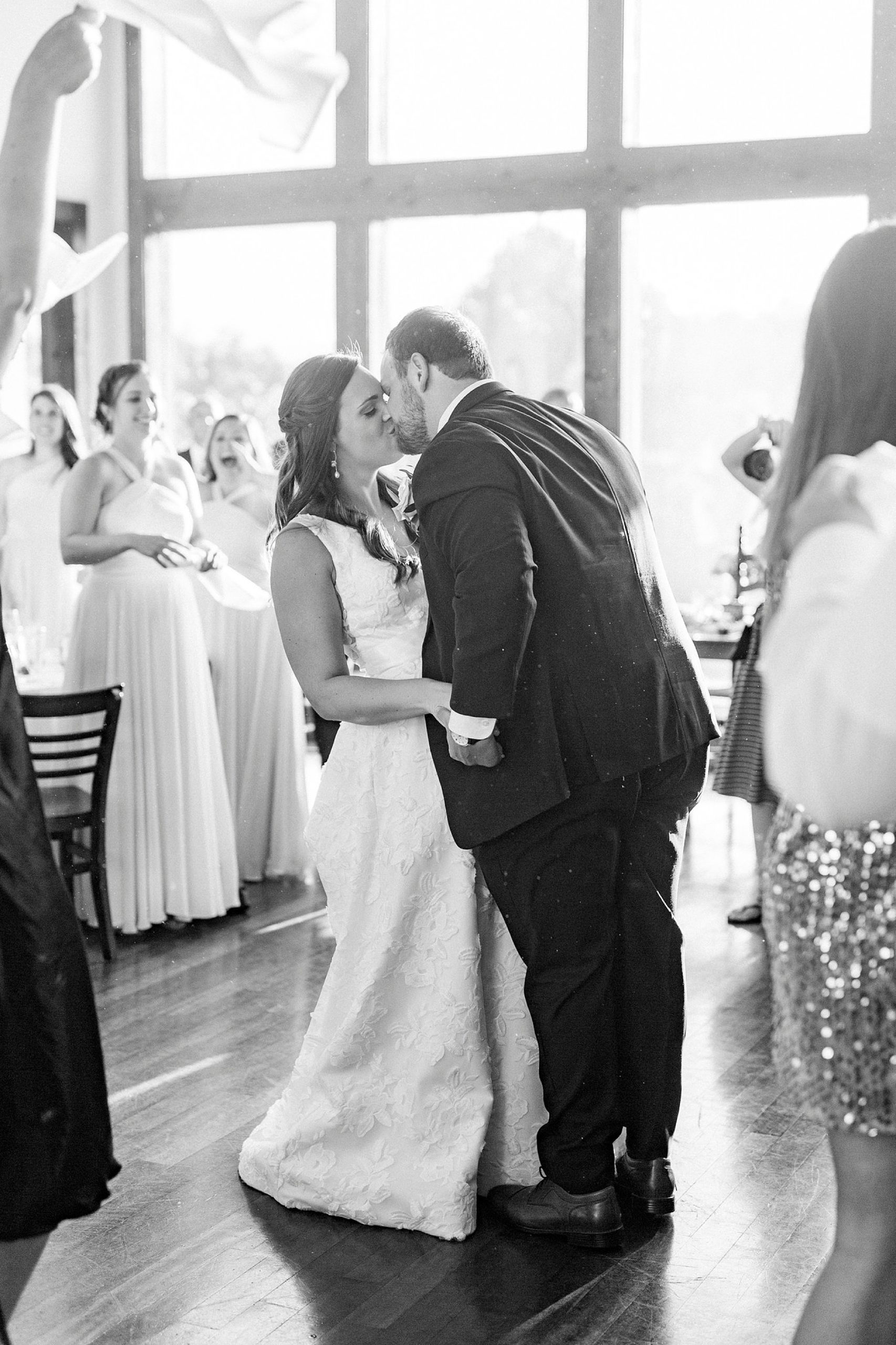 bride and groom kiss on dance floor
