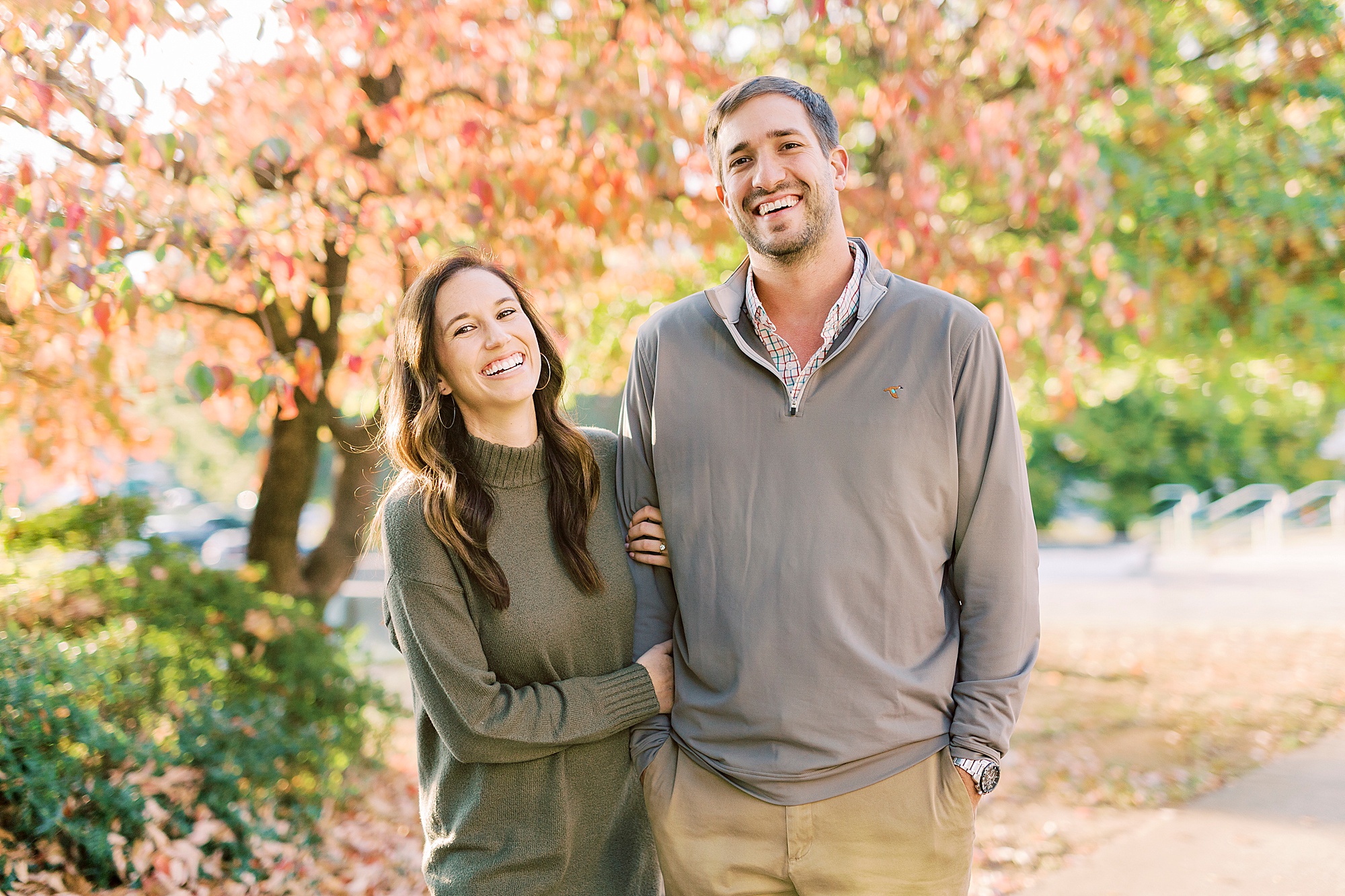 engaged couple laughs together during fall Marshall Park engagement session