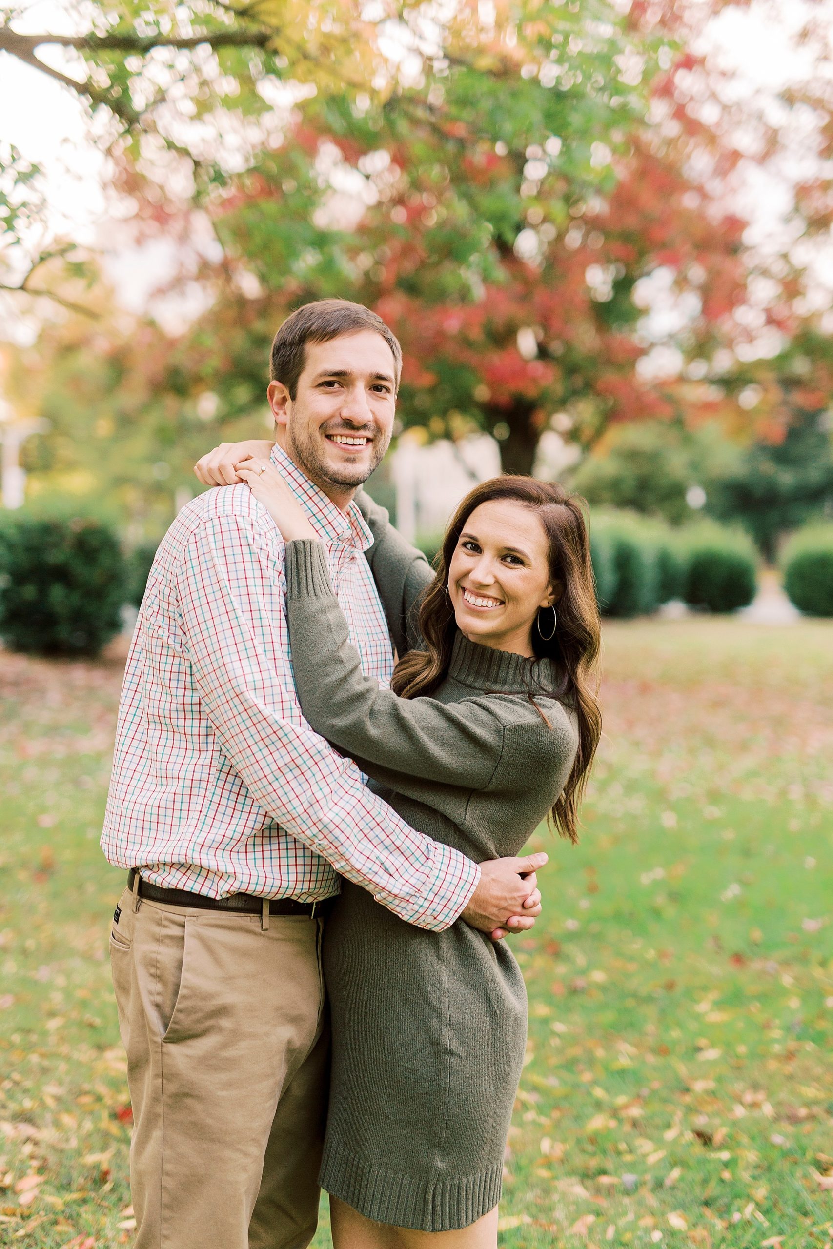 woman hugs groom smiling at camera