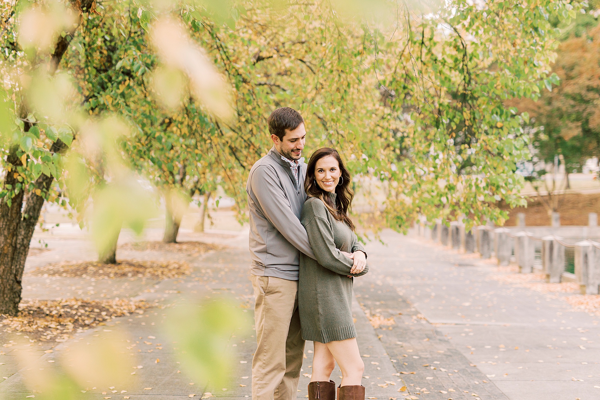 man hugs fiancee during Marshall Park engagement session