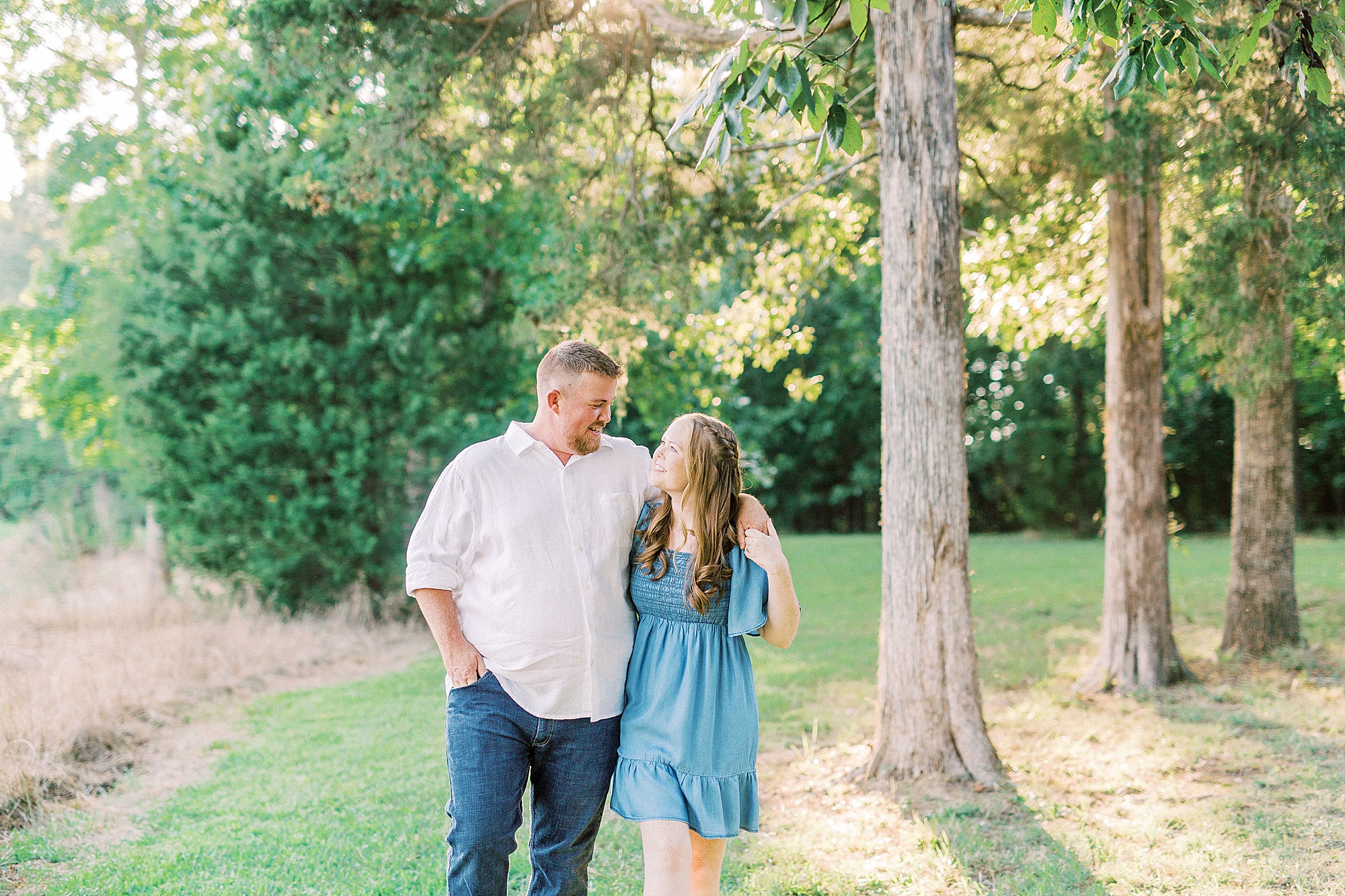 bride and groom walk through woods at Sunset Farm