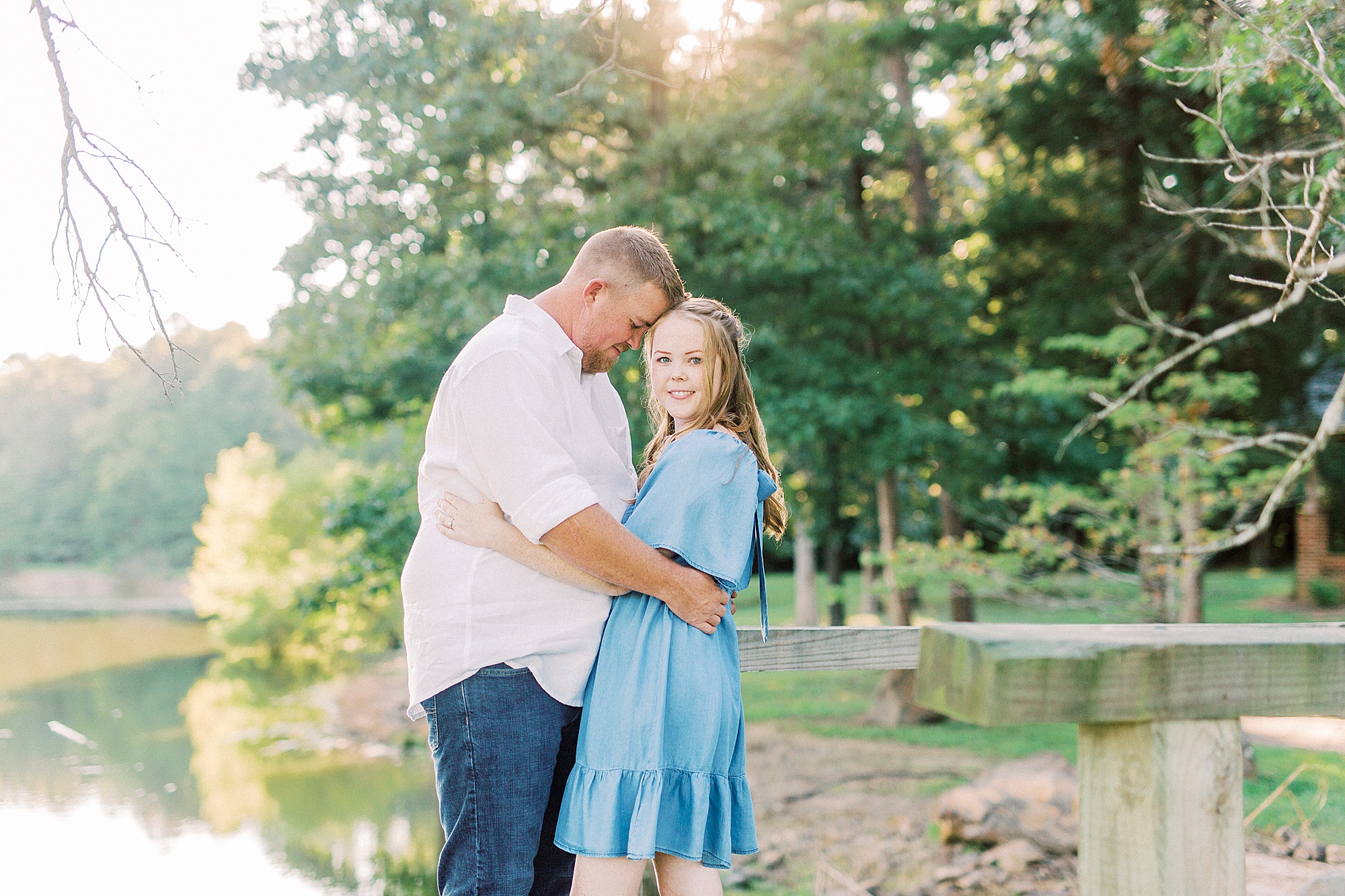 groom hugs bride during sunset Sunset Farm engagement session