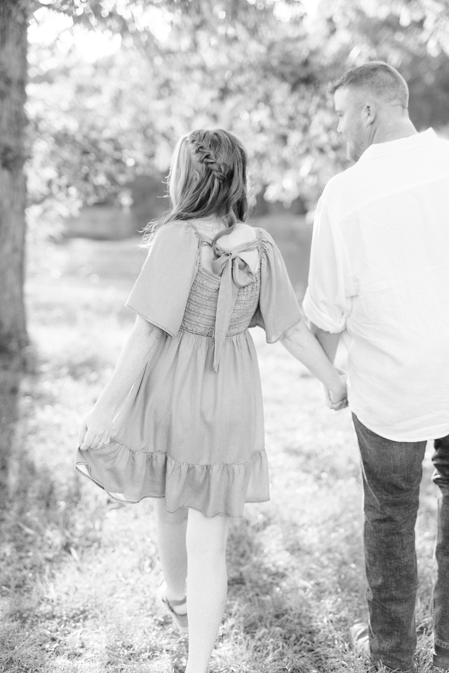 bride and groom hold hands walking through Sunset Farms