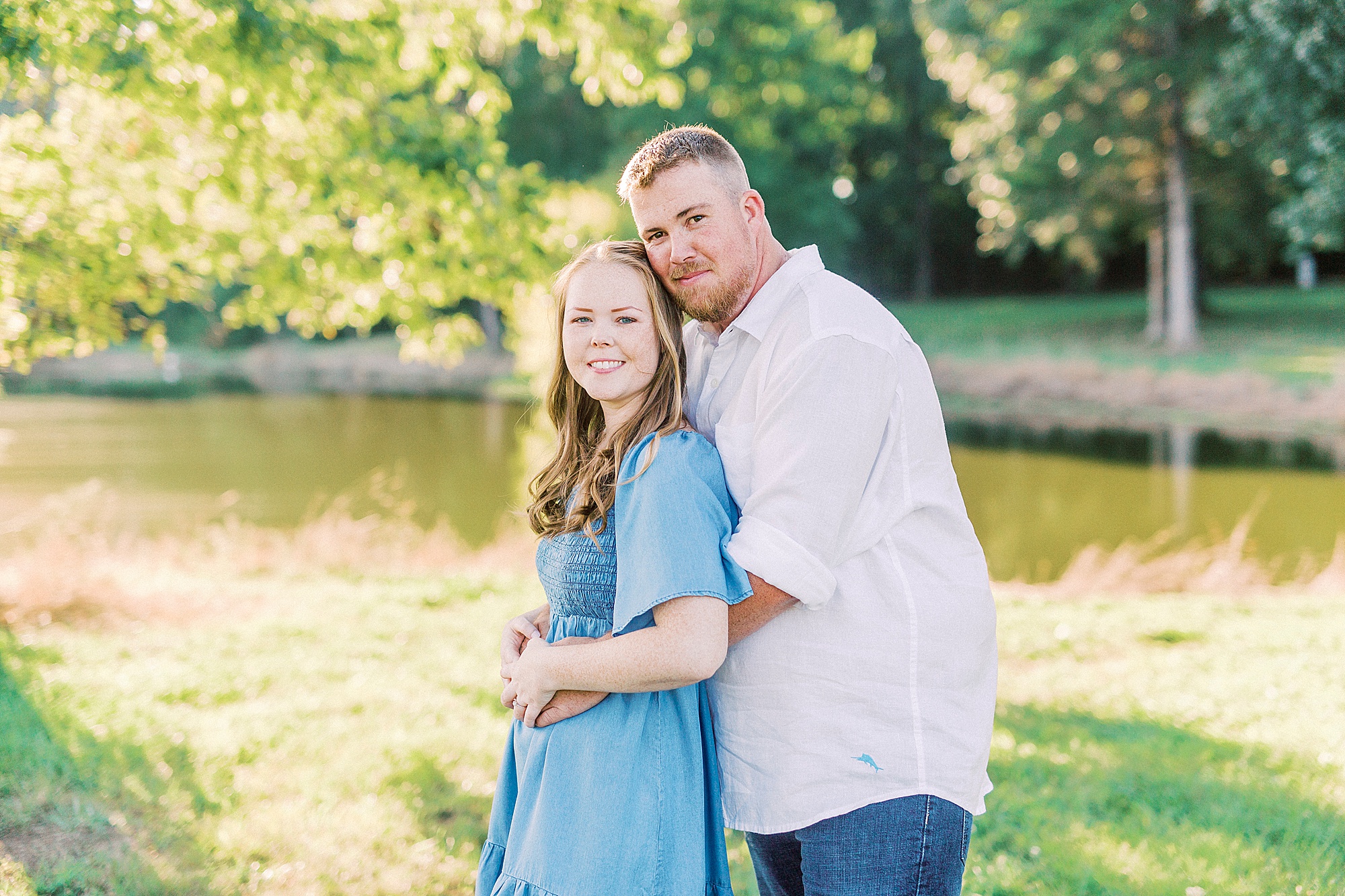 groom hugs bride from behind during NC engagement session