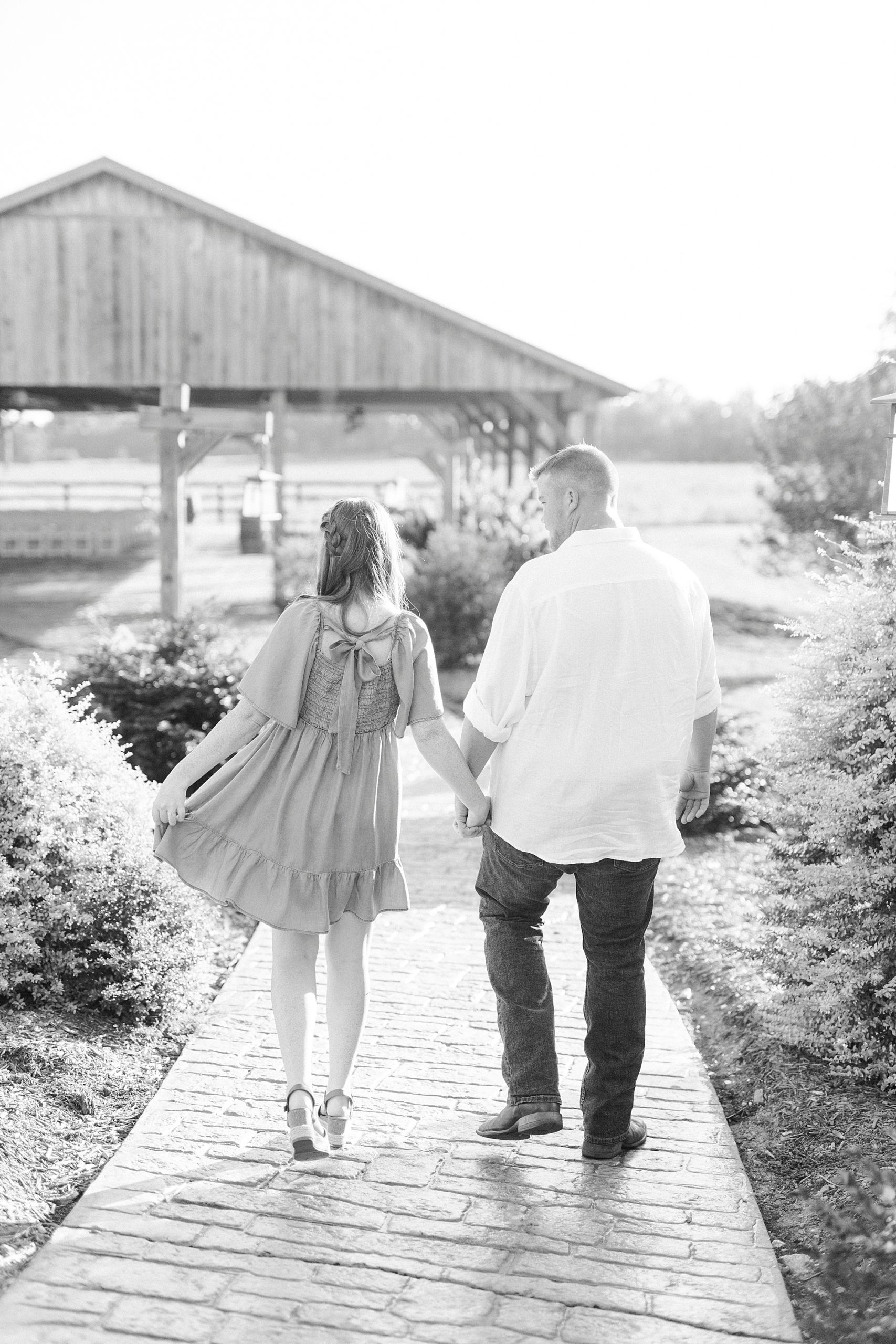 bride holds out skirt during engagement session