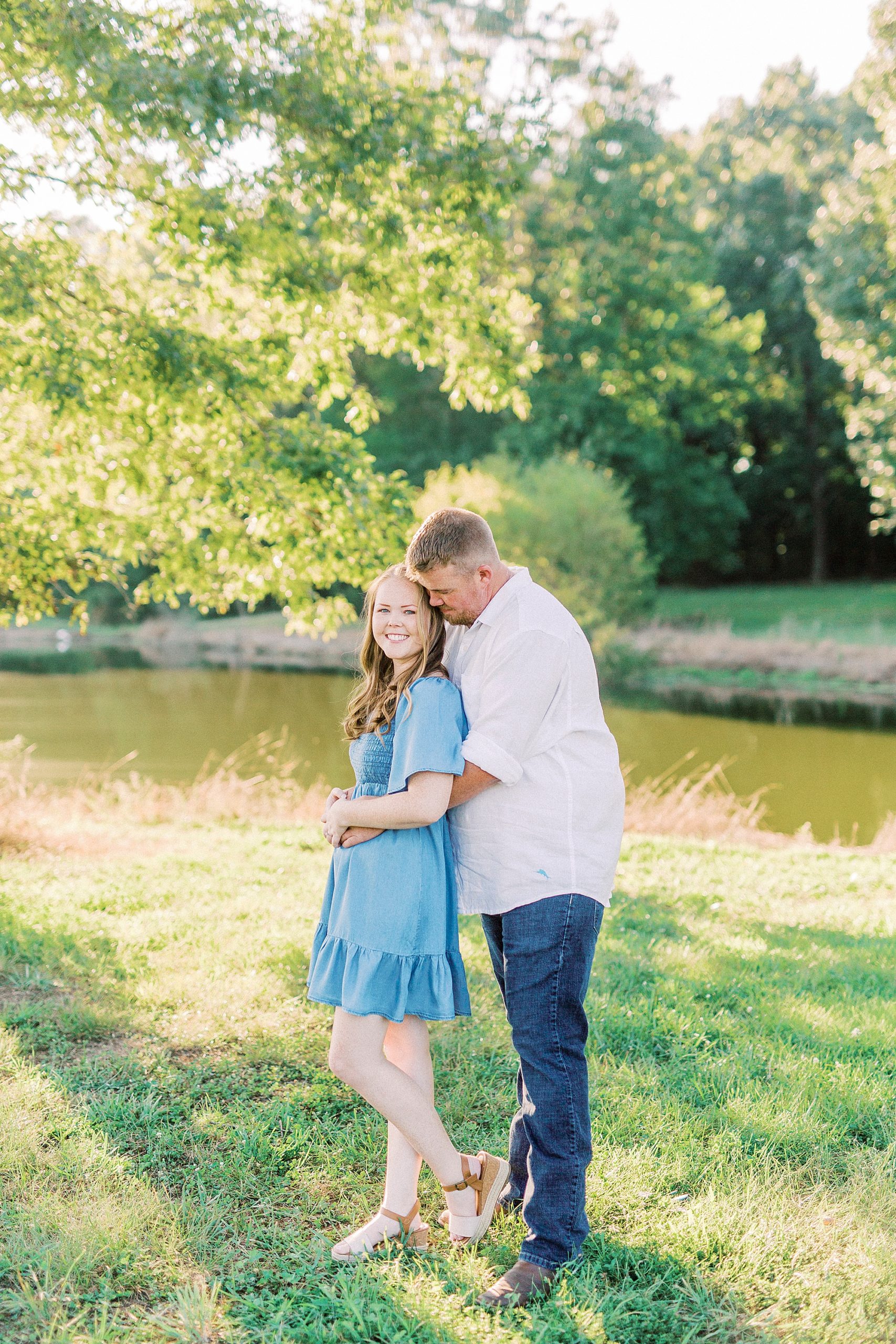 groom hugs bride from behind during NC engagement session