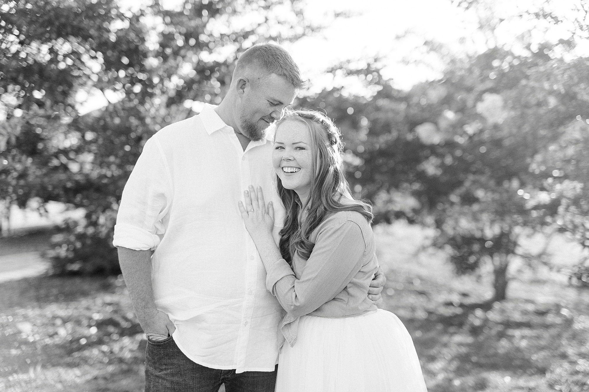 bride laughs leaning into groom during NC engagement session