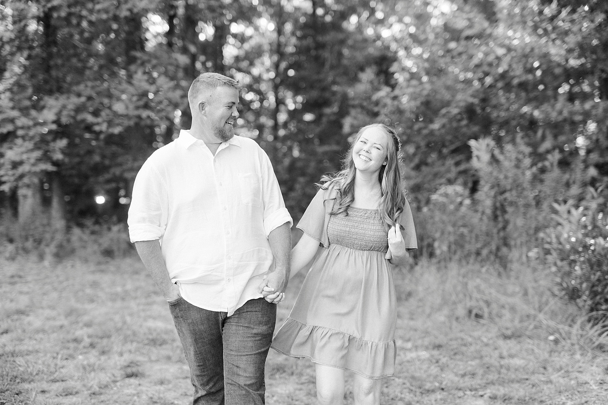 bride and groom hold hands laughing in Charlotte NC