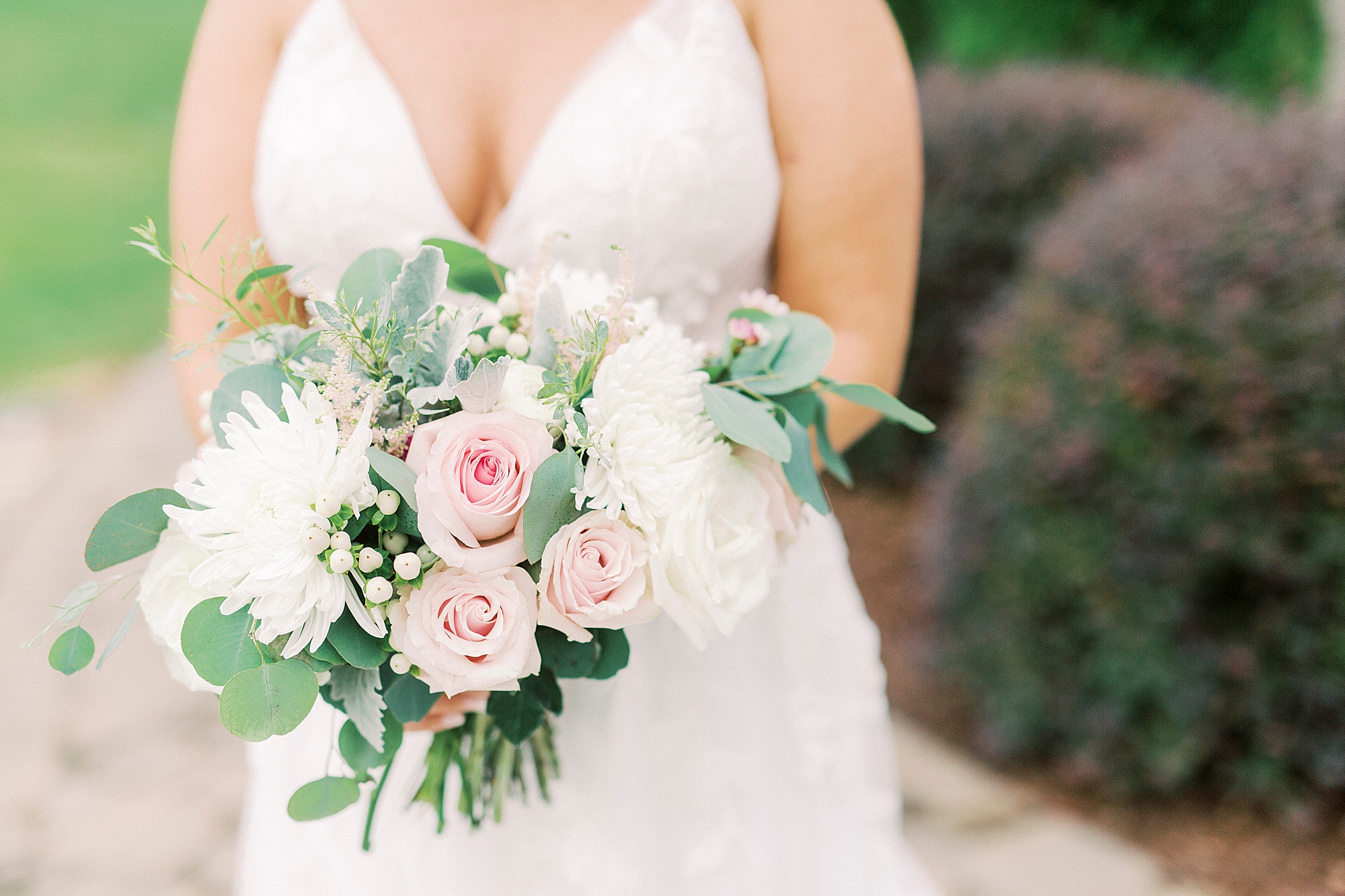 bride holds bouquet of pink flowers
