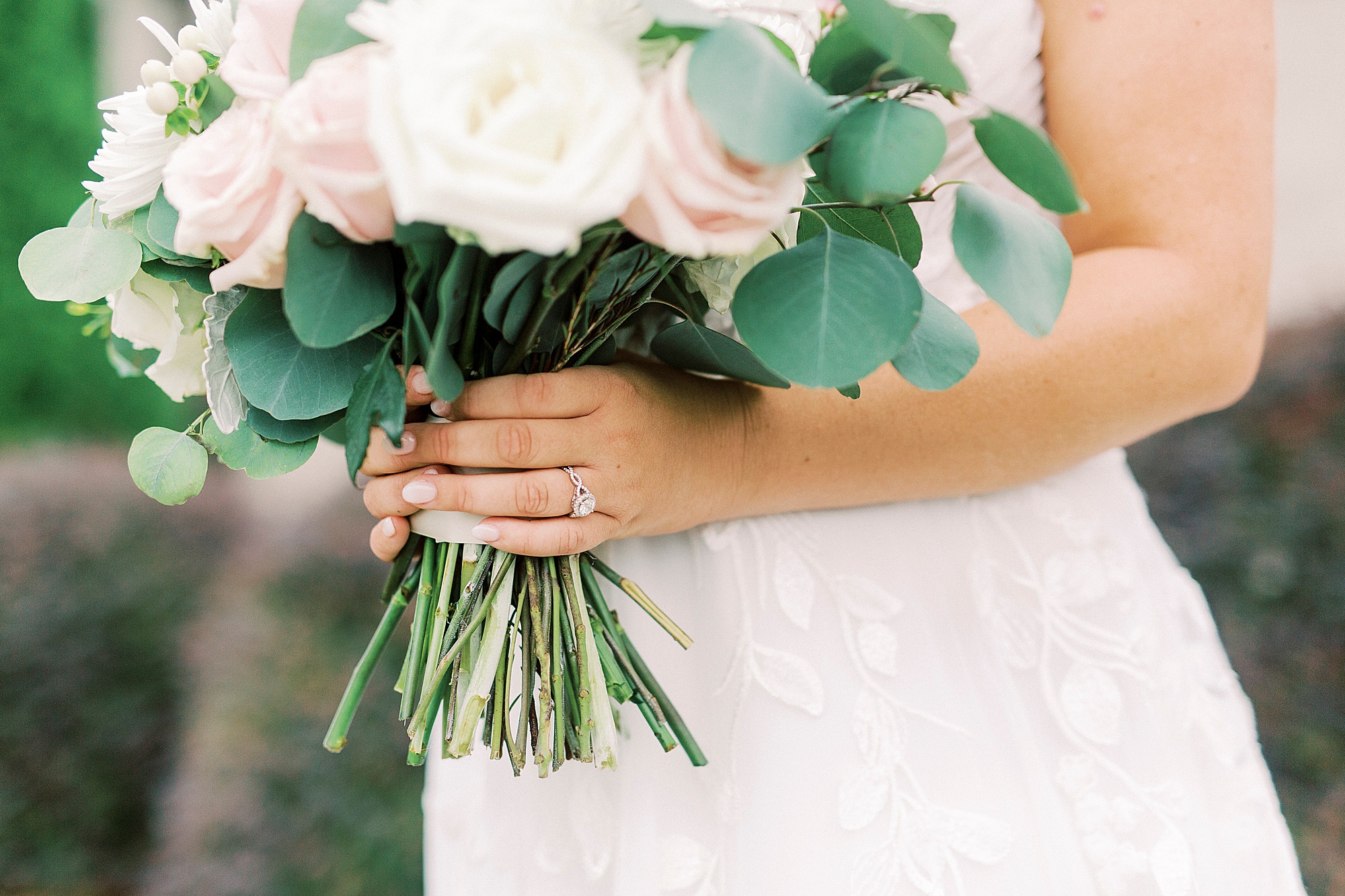 bride holds bouquet of pink and white flowers