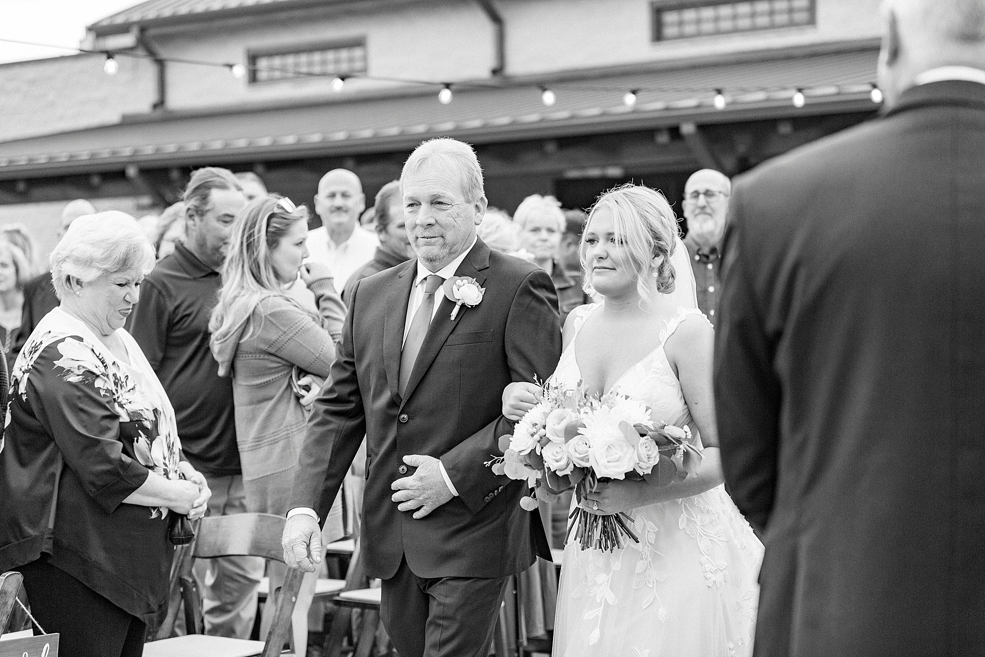 bride walks down aisle with dad during outdoor ceremony on farm in Greensboro NC
