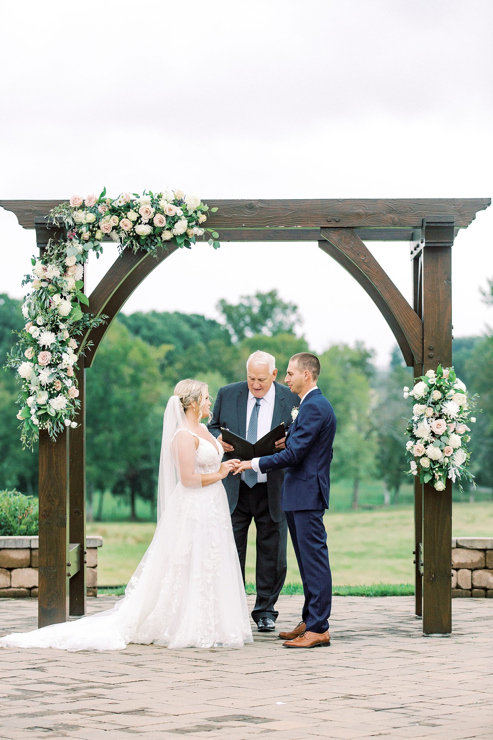 couple exchanges vows during outdoor ceremony on farm in Greensboro NC