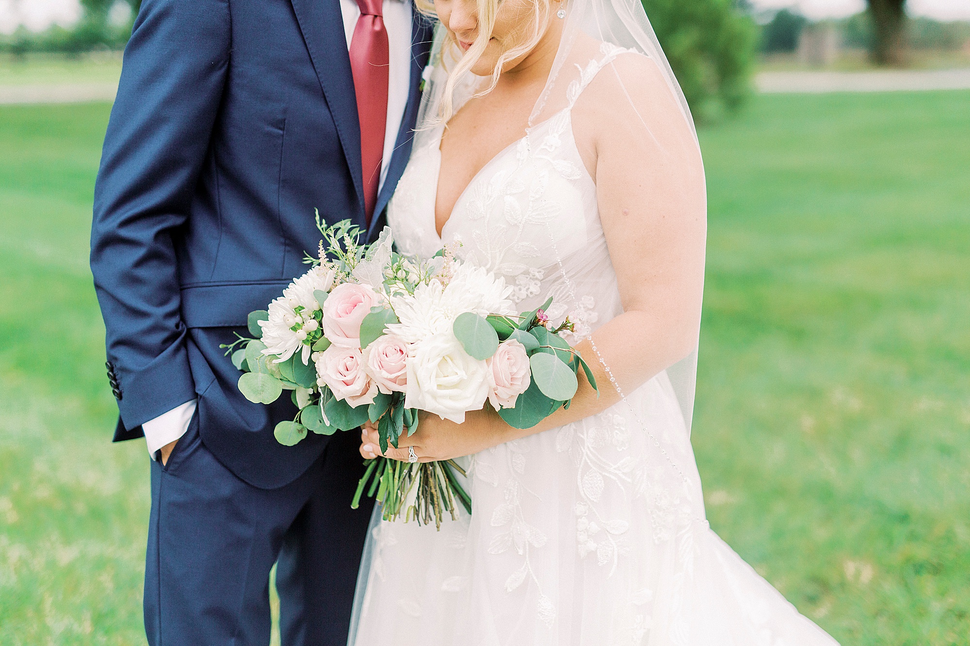 bride holds bouquet of white and pink flowers at Addison Farm