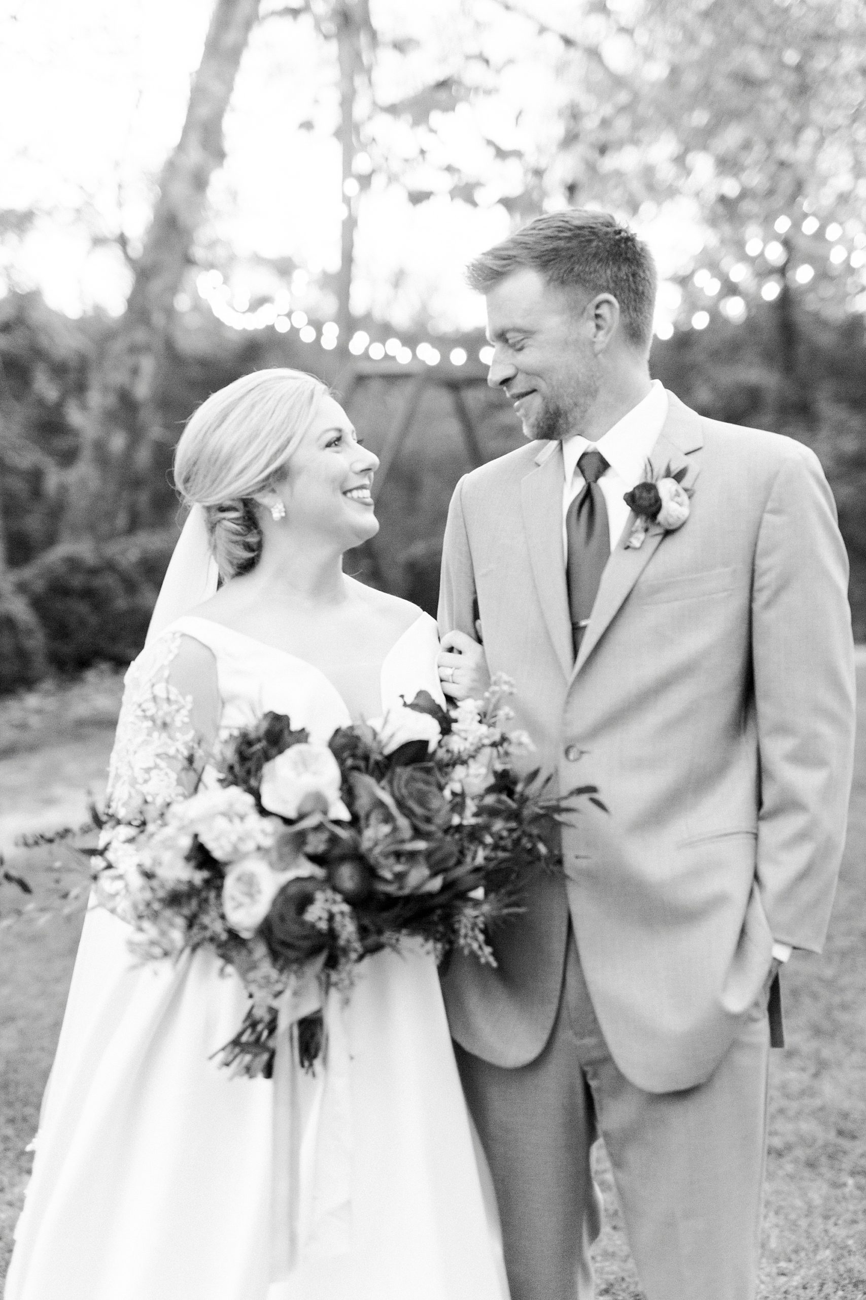 bride holds groom's arm during Vesuvius Vineyards wedding day