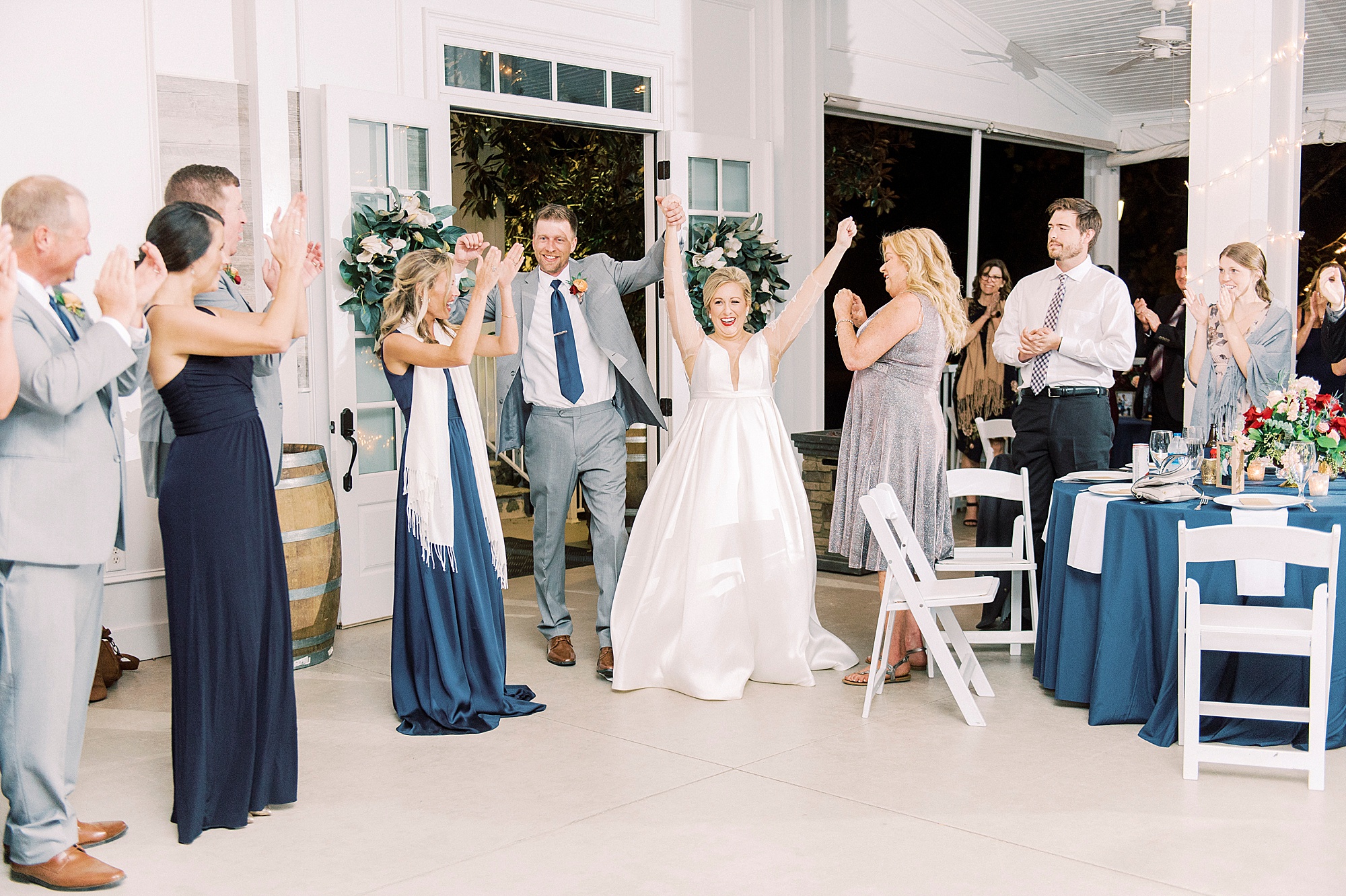 newlyweds cheer walking into NC wedding reception
