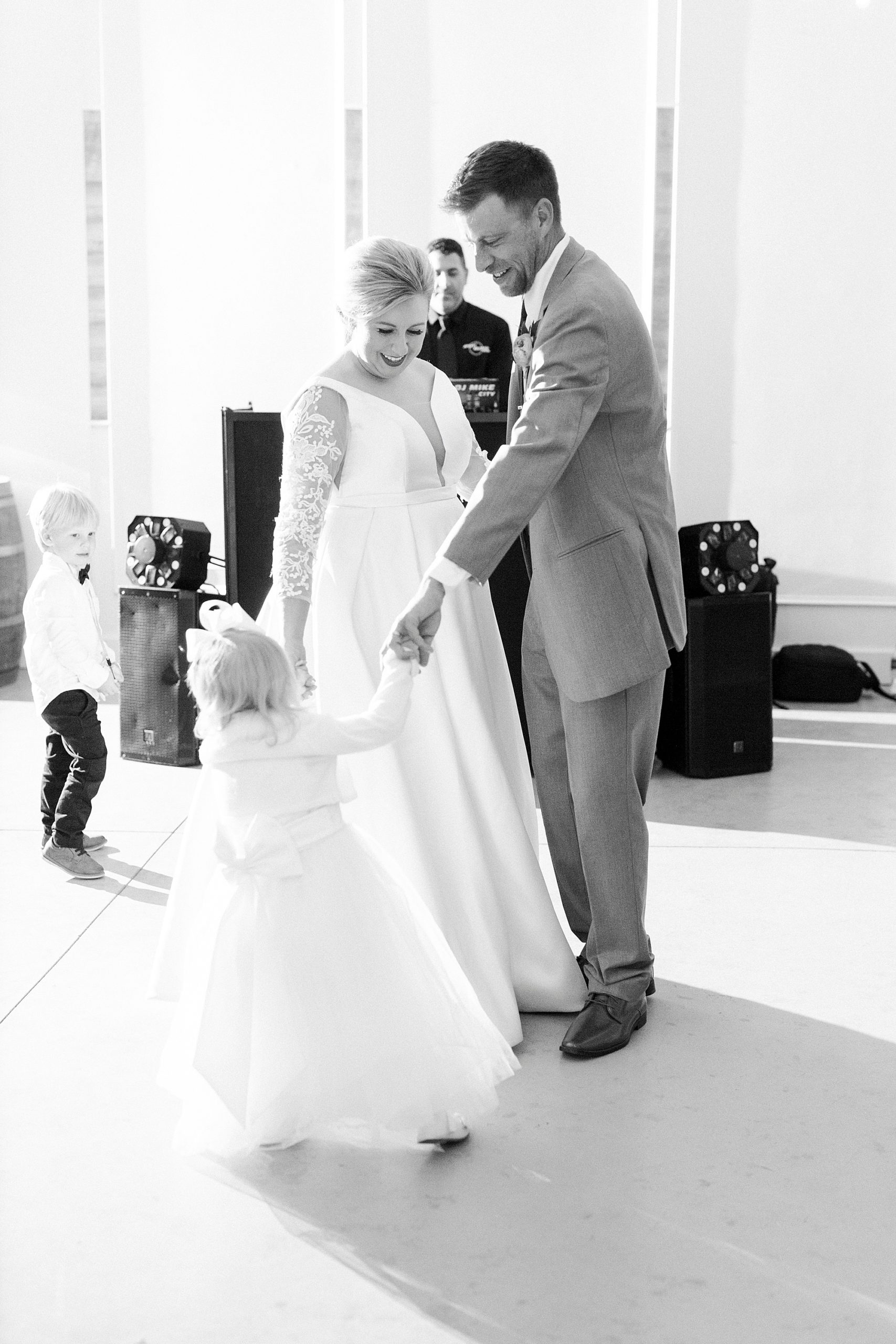 parents dance with daughter during NC wedding reception