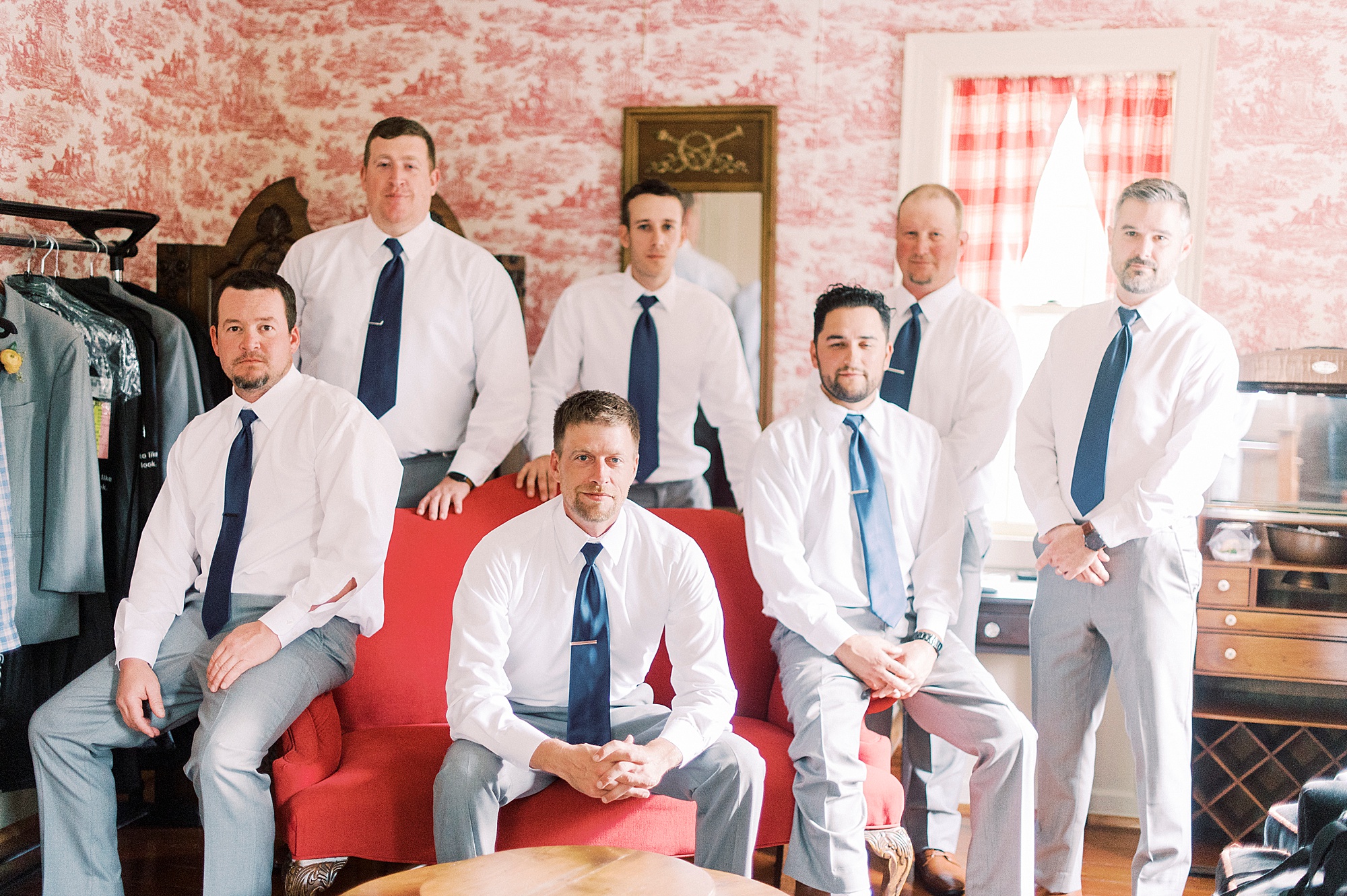 groom and groomsmen sit together before Vesuvius Vineyards wedding