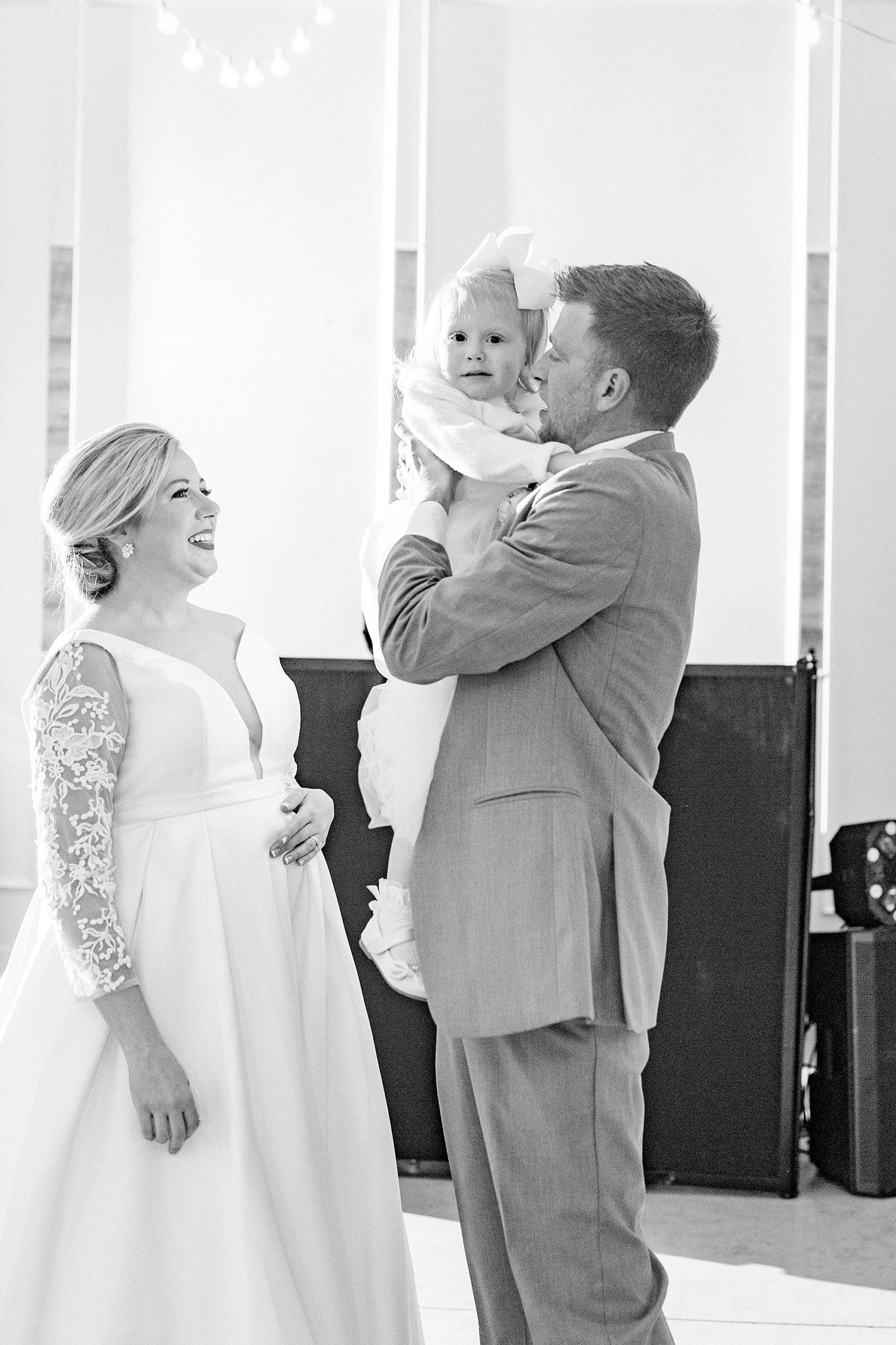 groom hugs daughter during wedding dances
