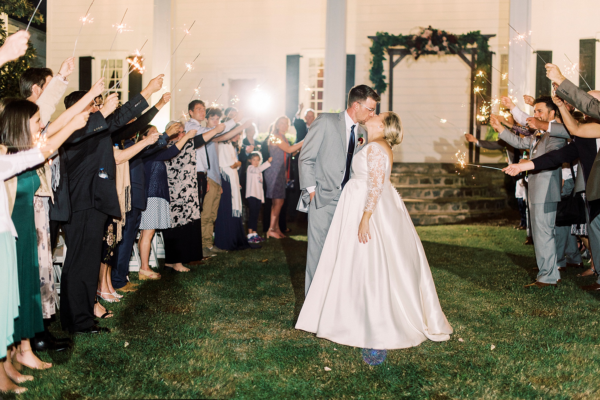 newlyweds kiss outside Vesuvius Vineyards during sparkler exit