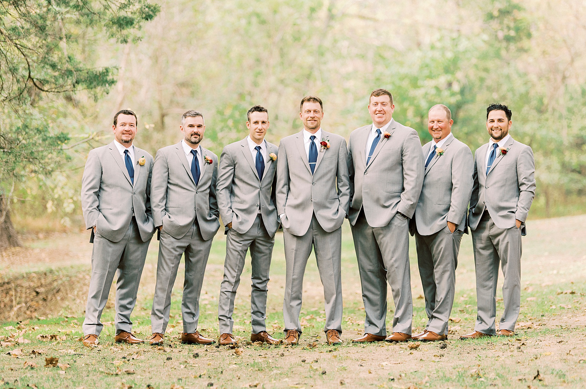 groomsmen in grey suits pose together for Vesuvius Vineyards wedding day