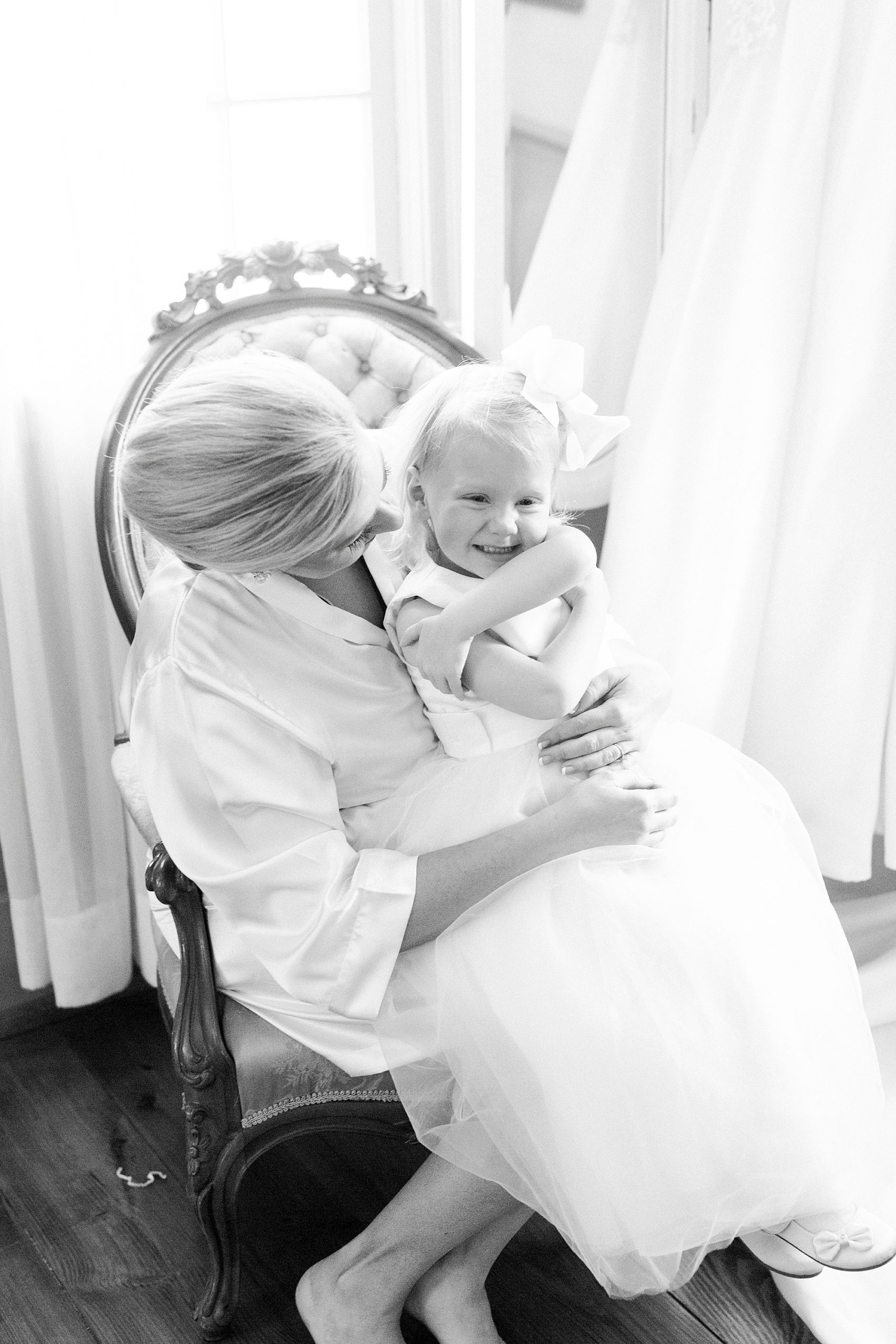bride hugs daughter on wedding day