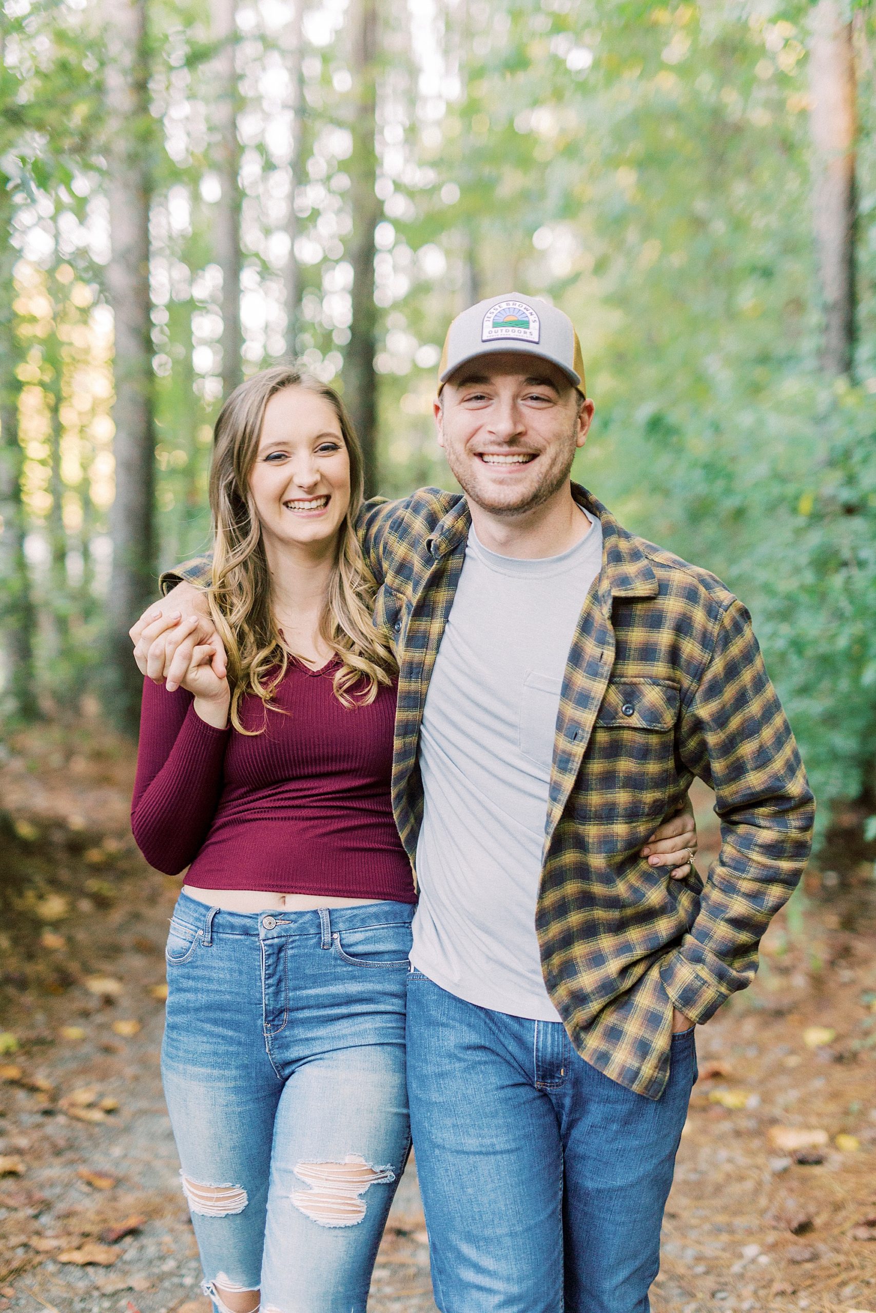 groom hugs bride around shoulders during Whitewater Center engagement session