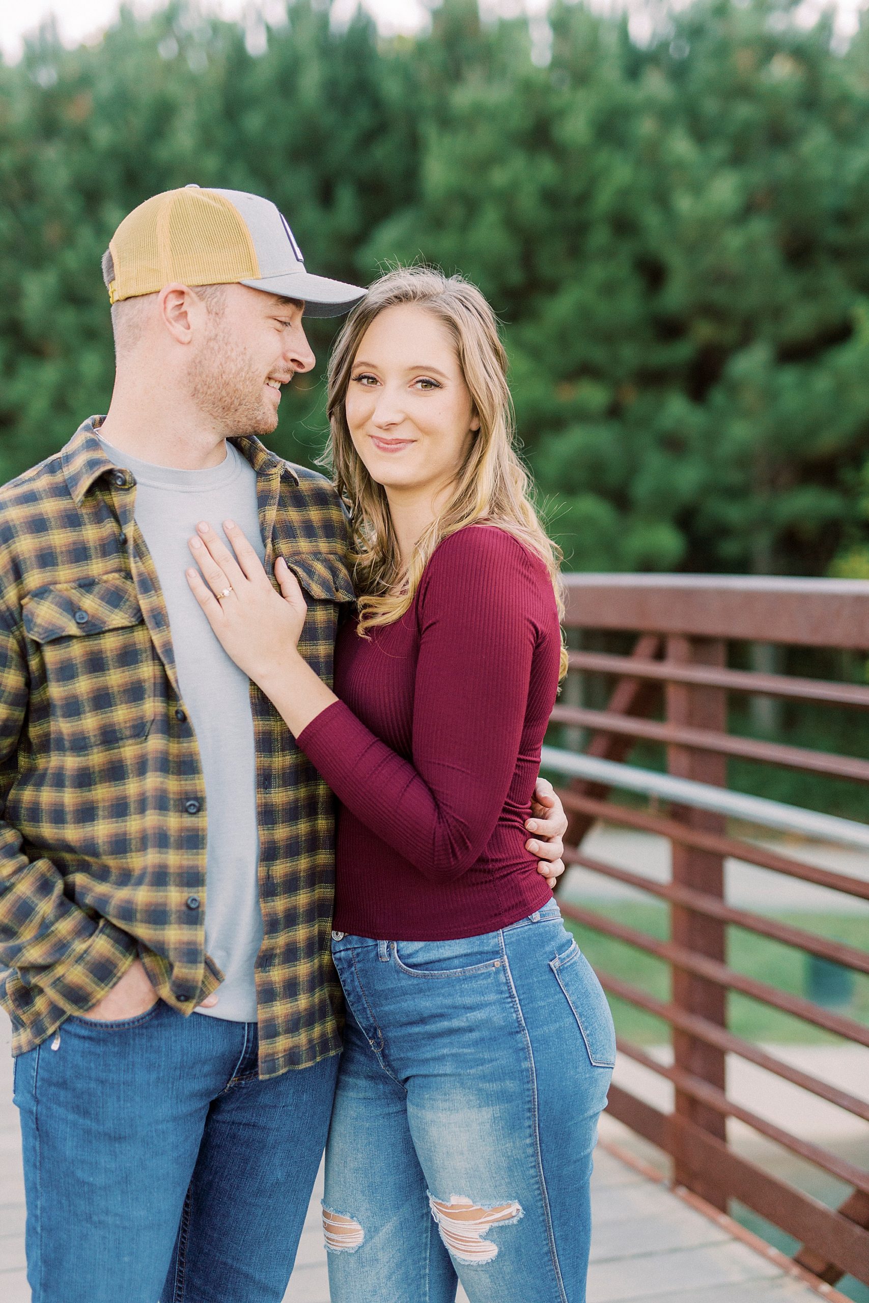 bride and groom stand on bridge at the Whitewater Center