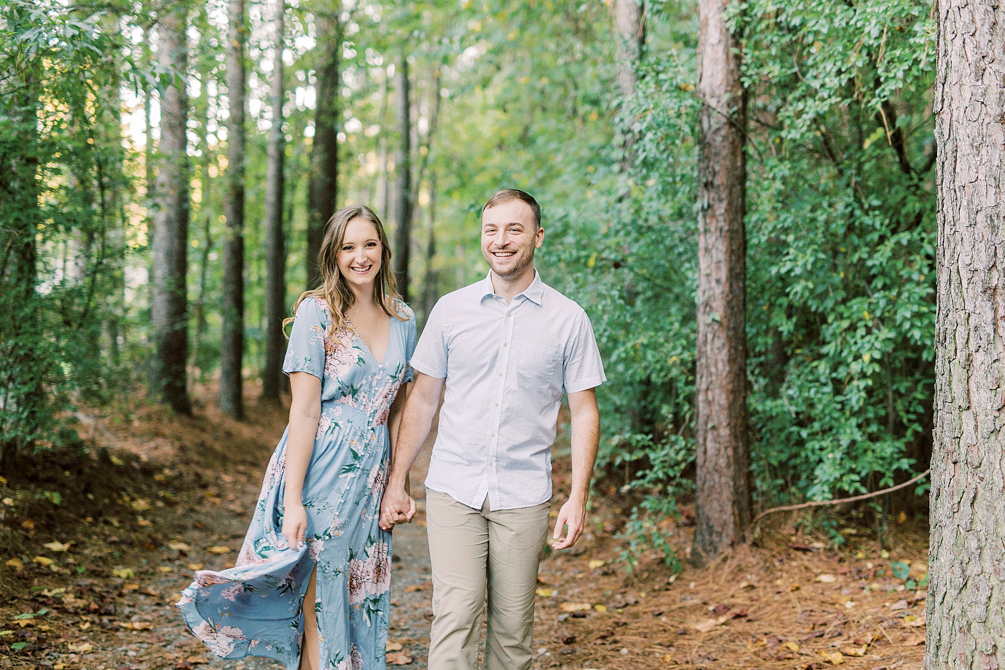 bride twirls skirt while walking with groom at Whitewater Center