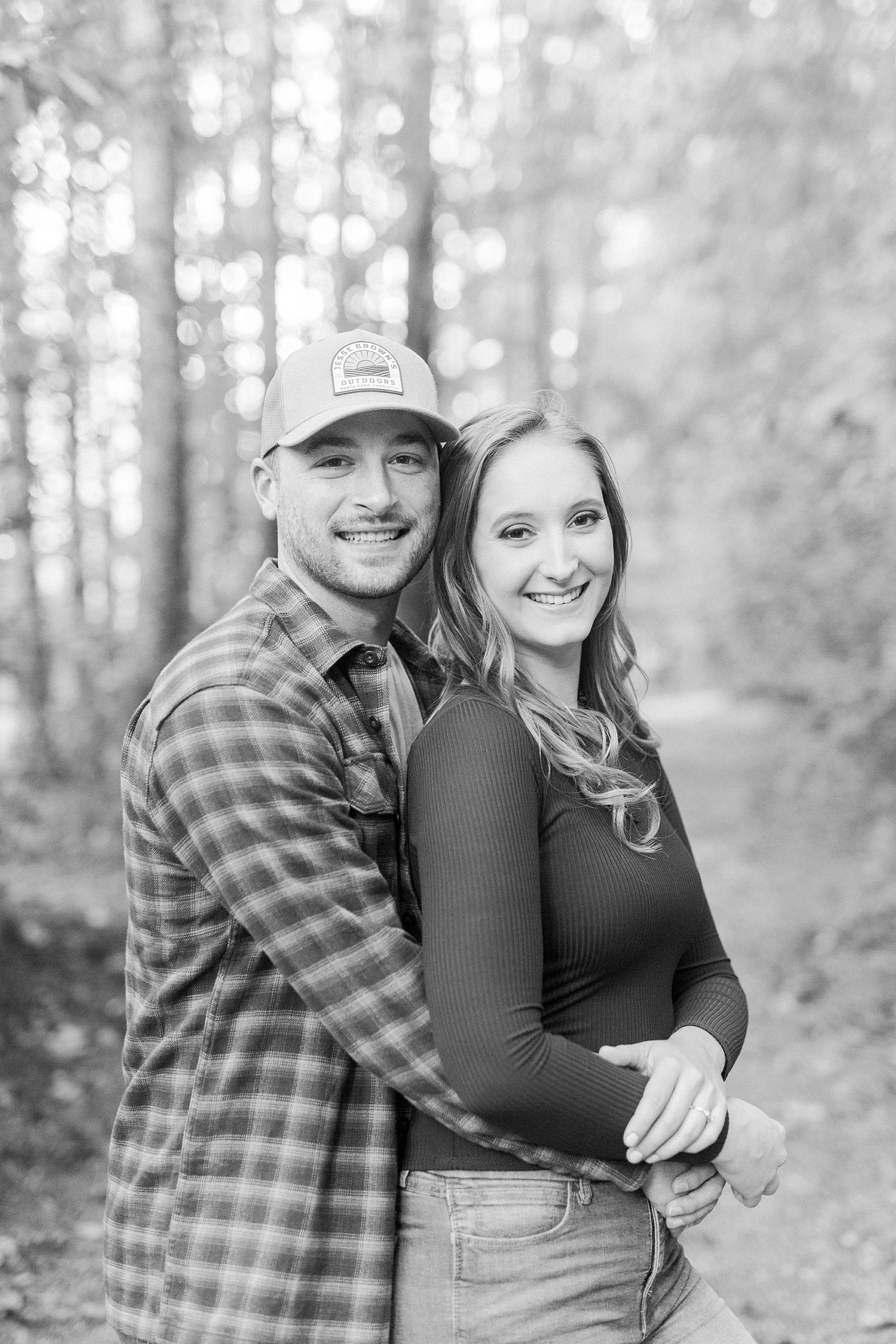 groom hugs bride from behind during Whitewater Center engagement session