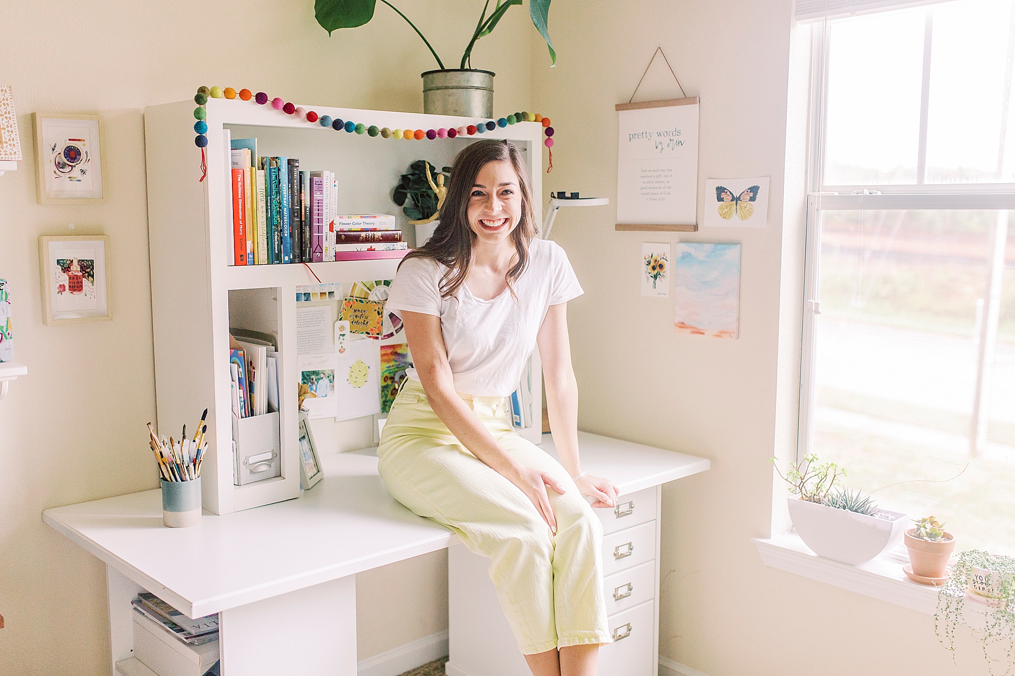 watercolor artist sits on desk in Charlotte home