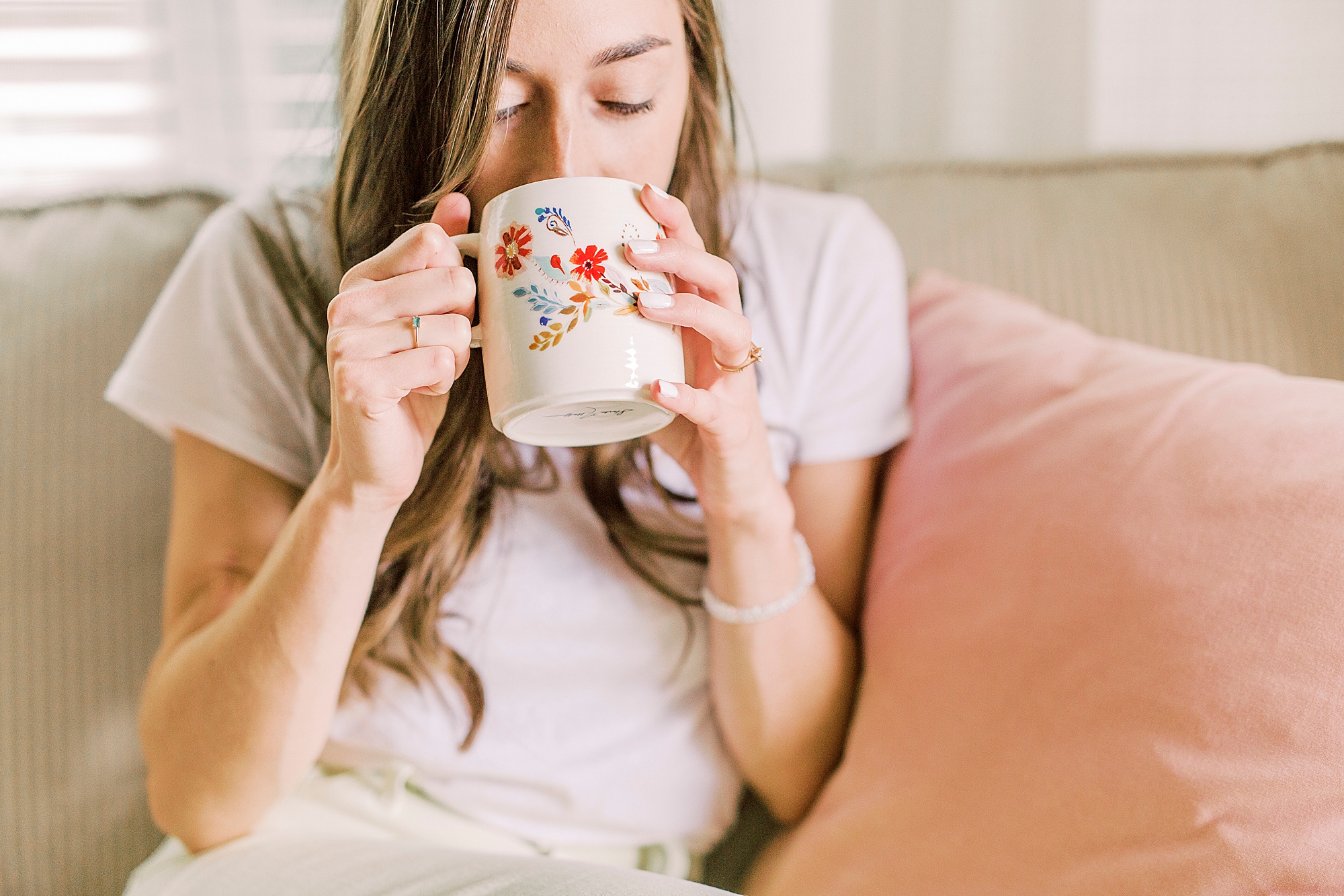 woman sips out of colorful coffee mug in Charlotte NC