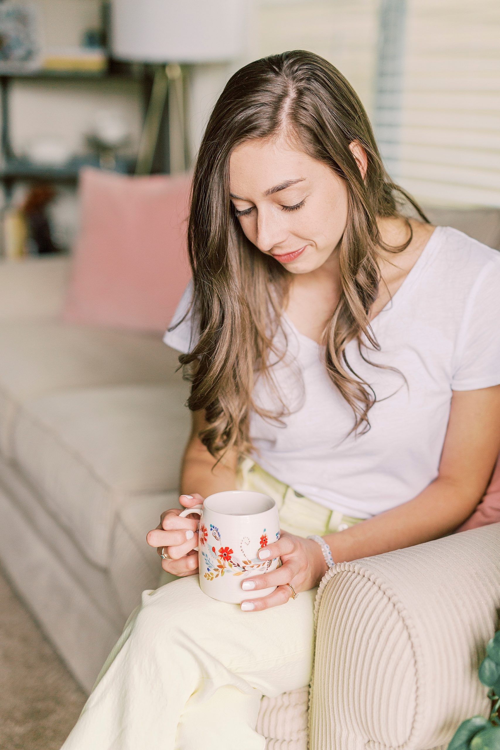 woman looks down at coffee mug during branding photos in Charlotte NC