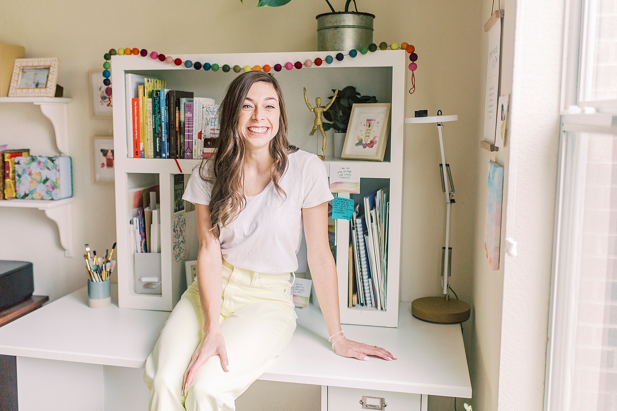 artist leans on desk during Charlotte Branding Session