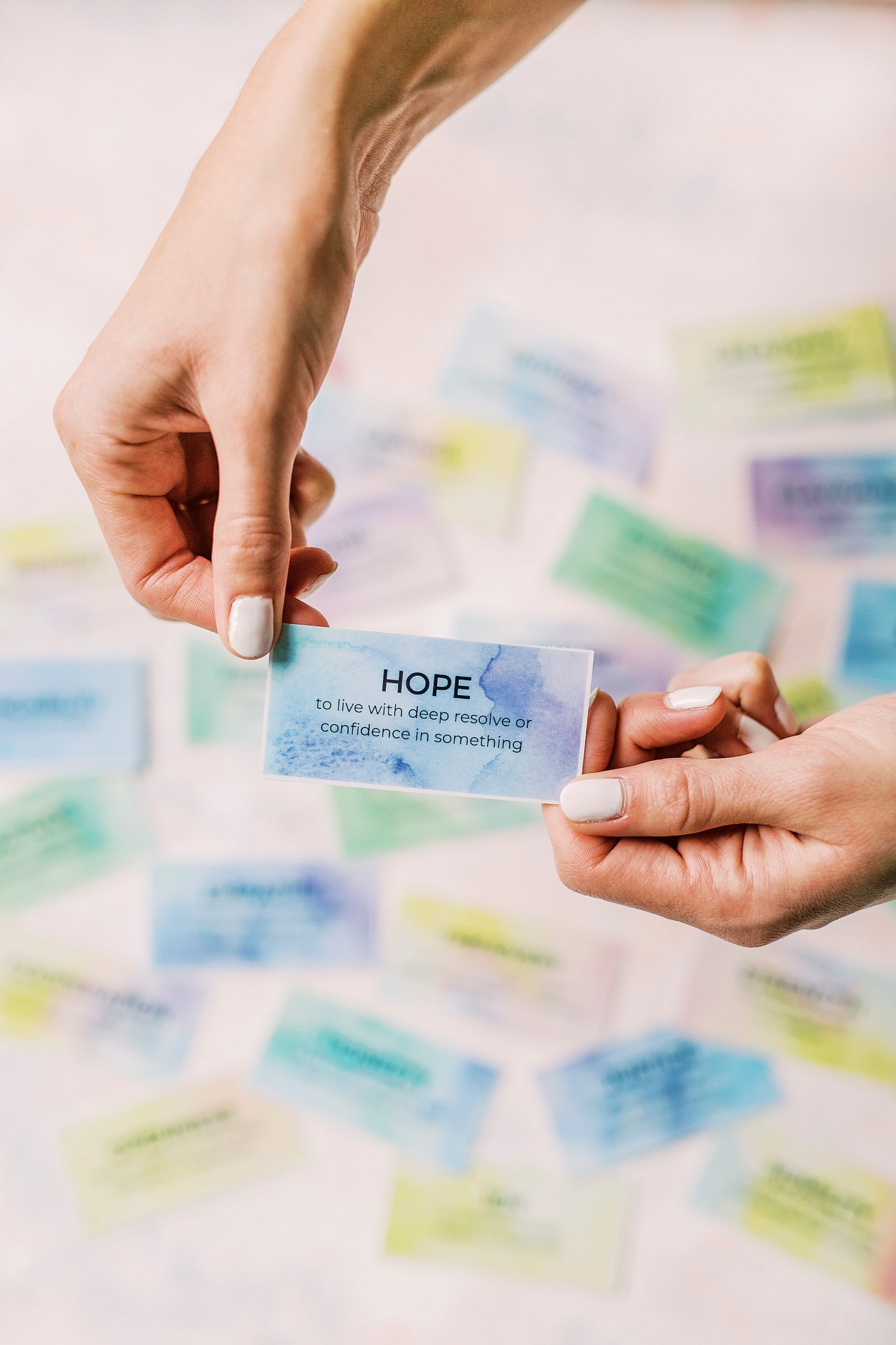 woman holds affirmation on watercolor paper during Charlotte branding session