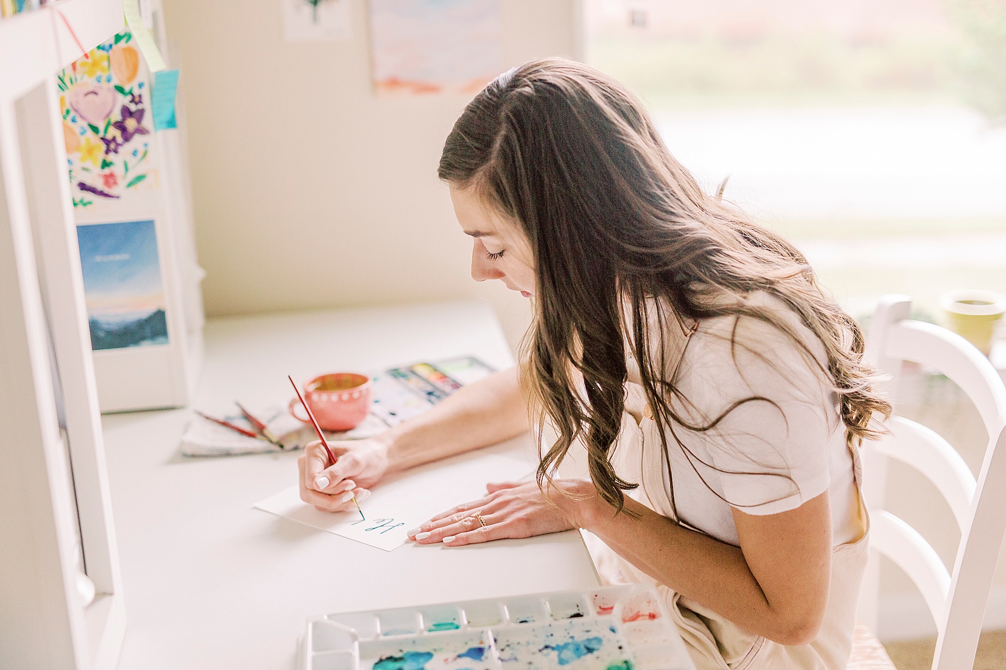 watercolor artist works in home studio during Charlotte branding session