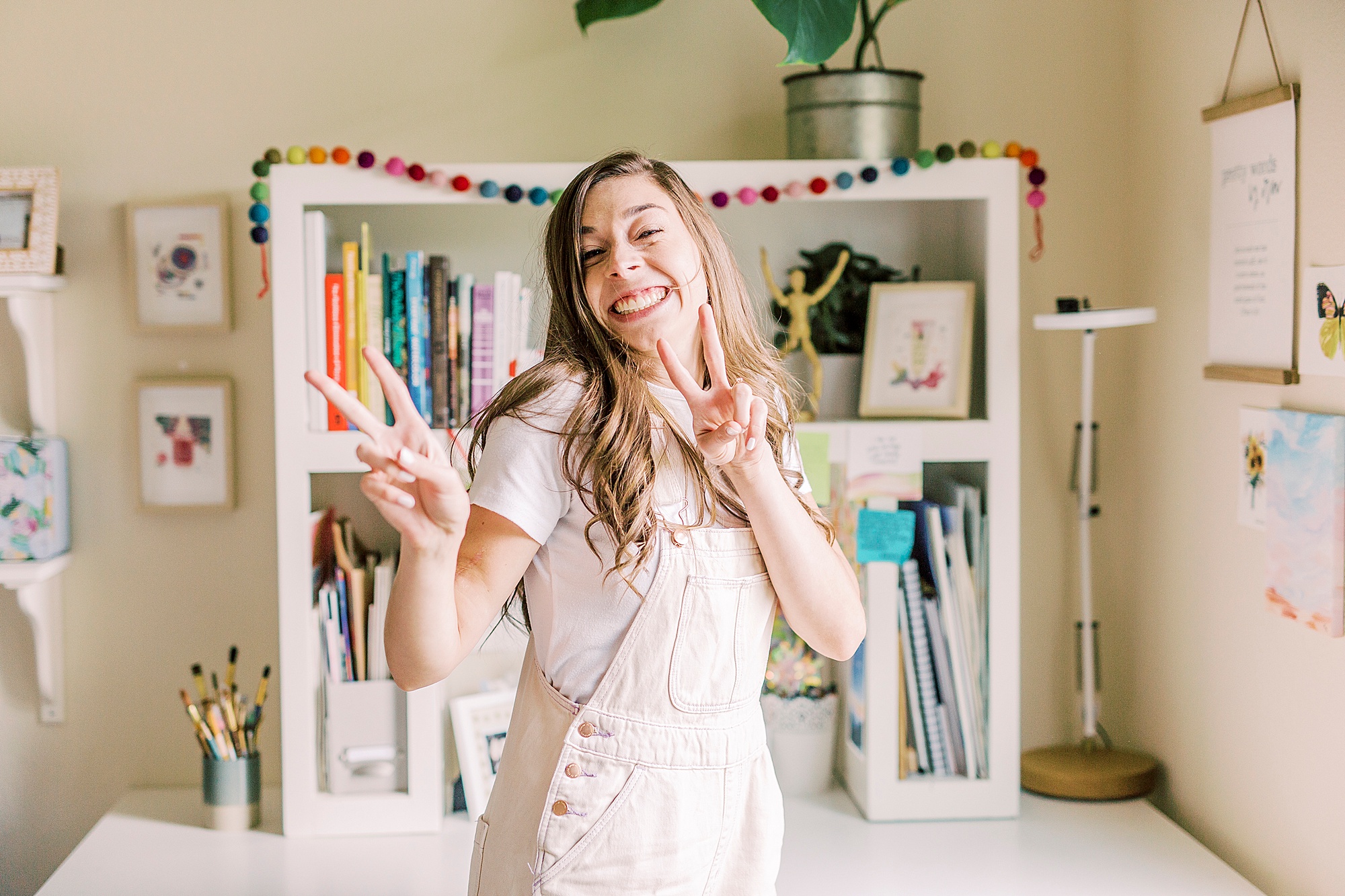 artist poses playful in home studio during Charlotte branding session