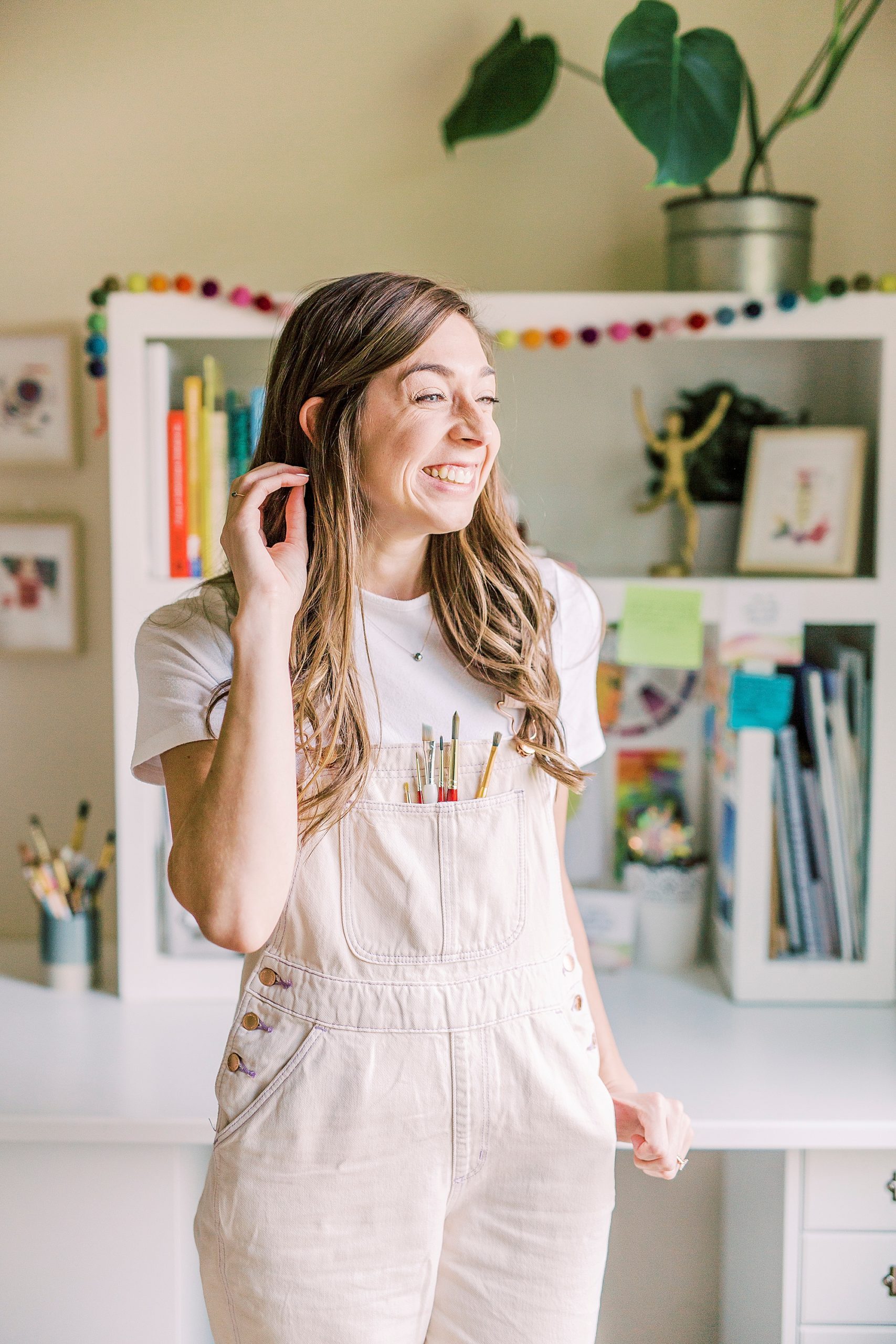 woman pushes hair behind her ear during branding photos at home
