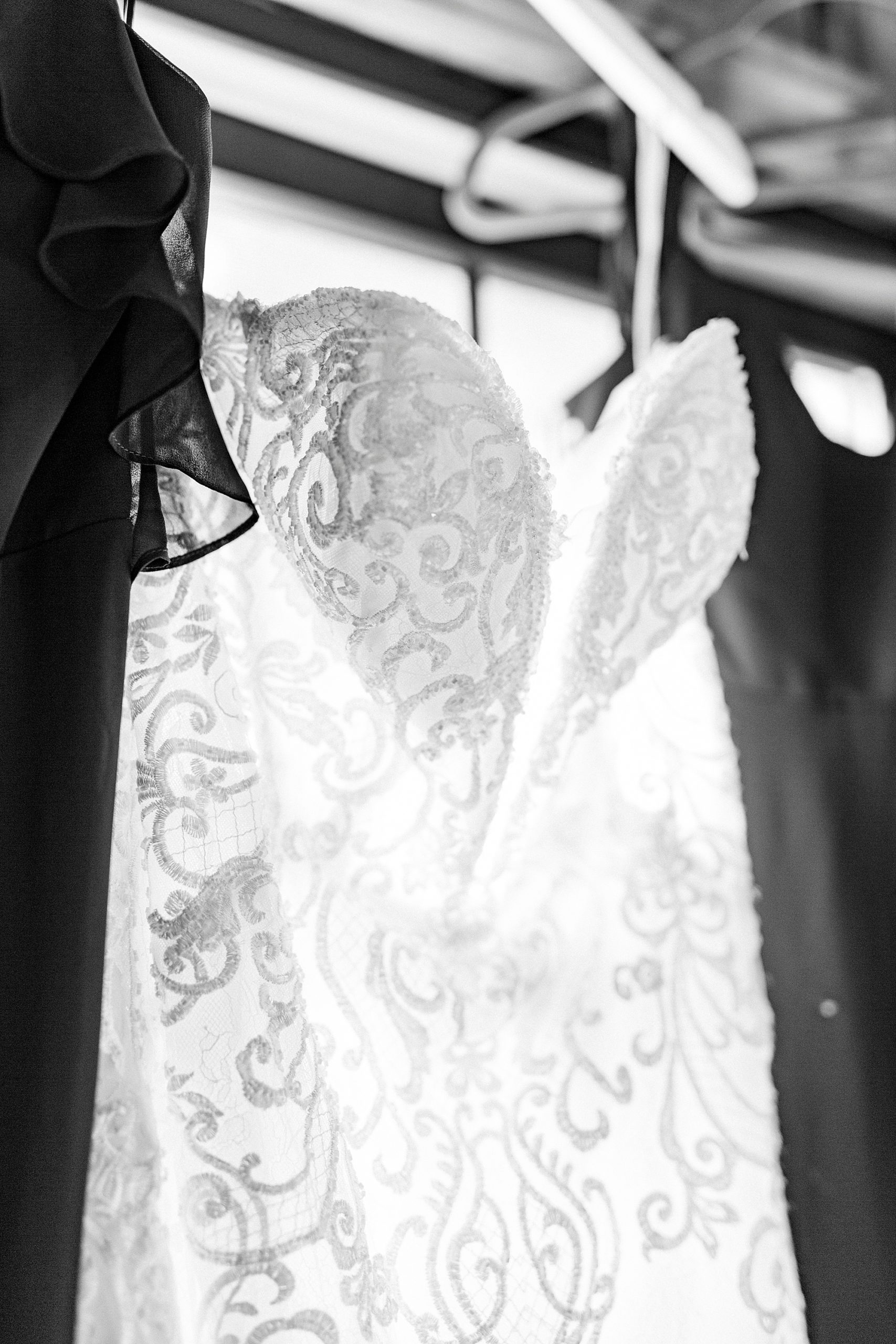 wedding dress hangs with bridesmaid gowns