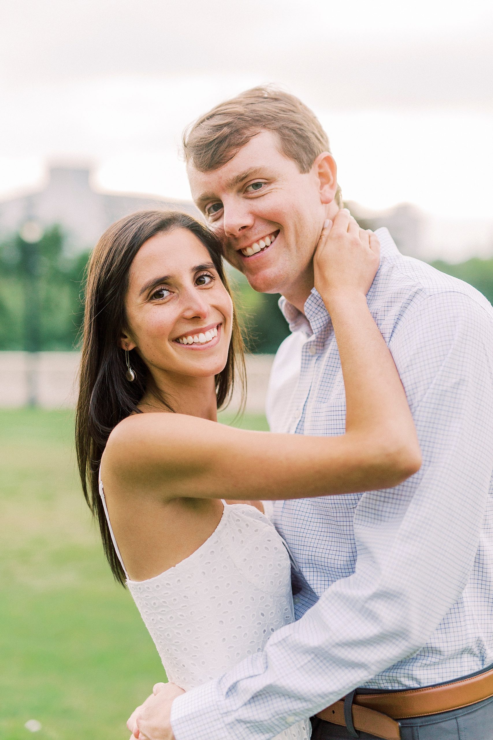 bride hugs groom during sunset Midtown Park engagement photos