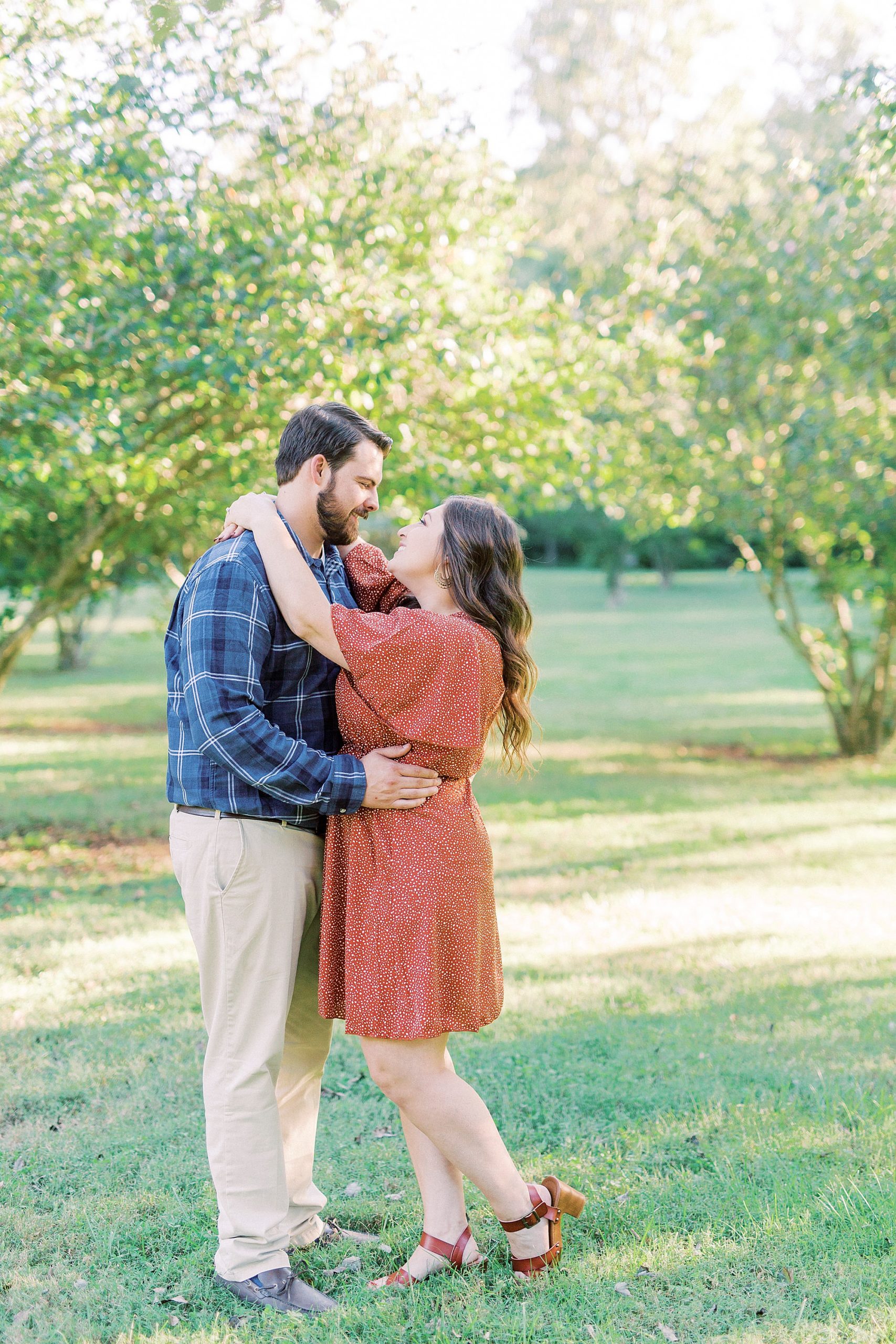 bride and groom hug in the fall at Sloan Park
