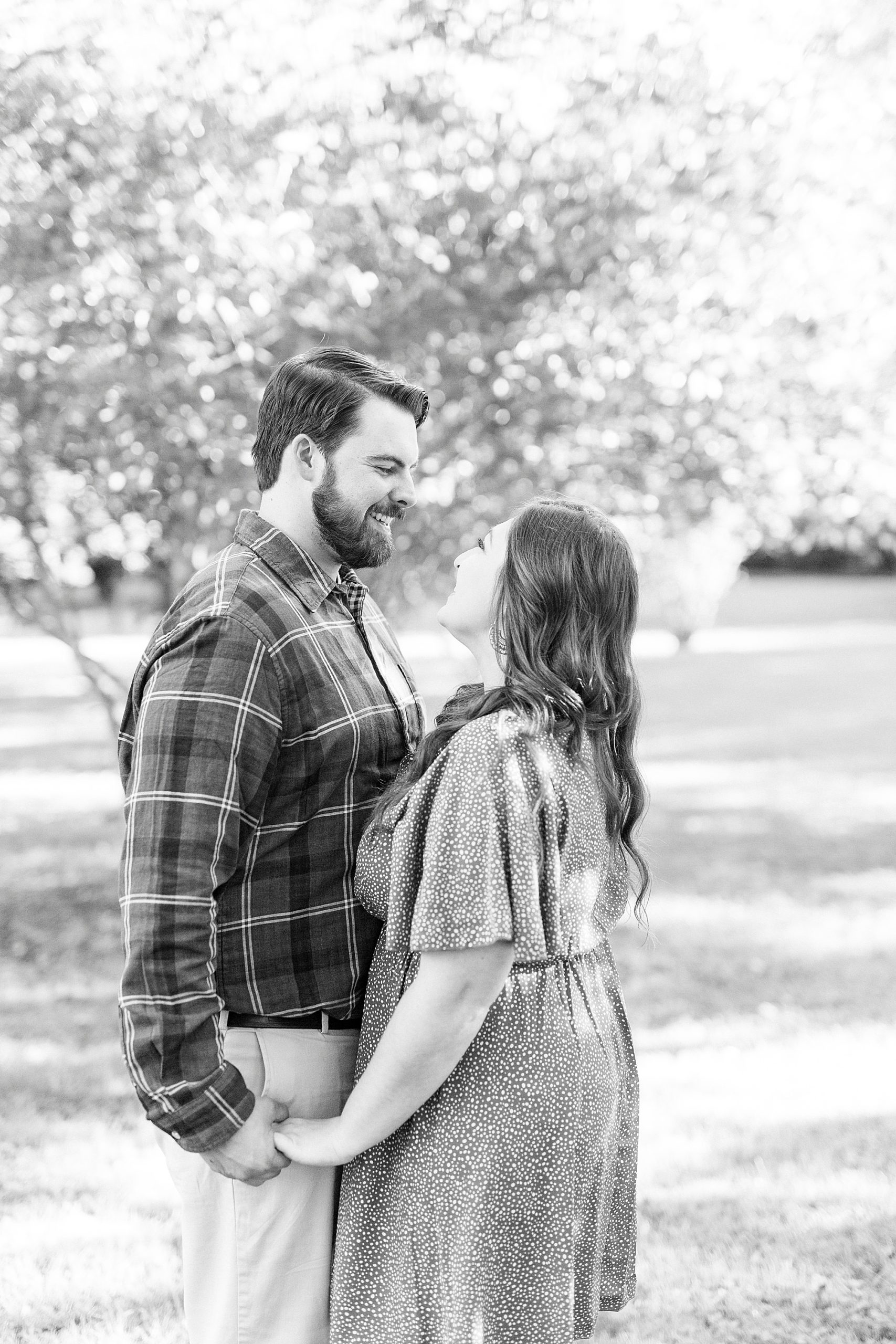 bride and groom holds looking at each other during fall portraits
