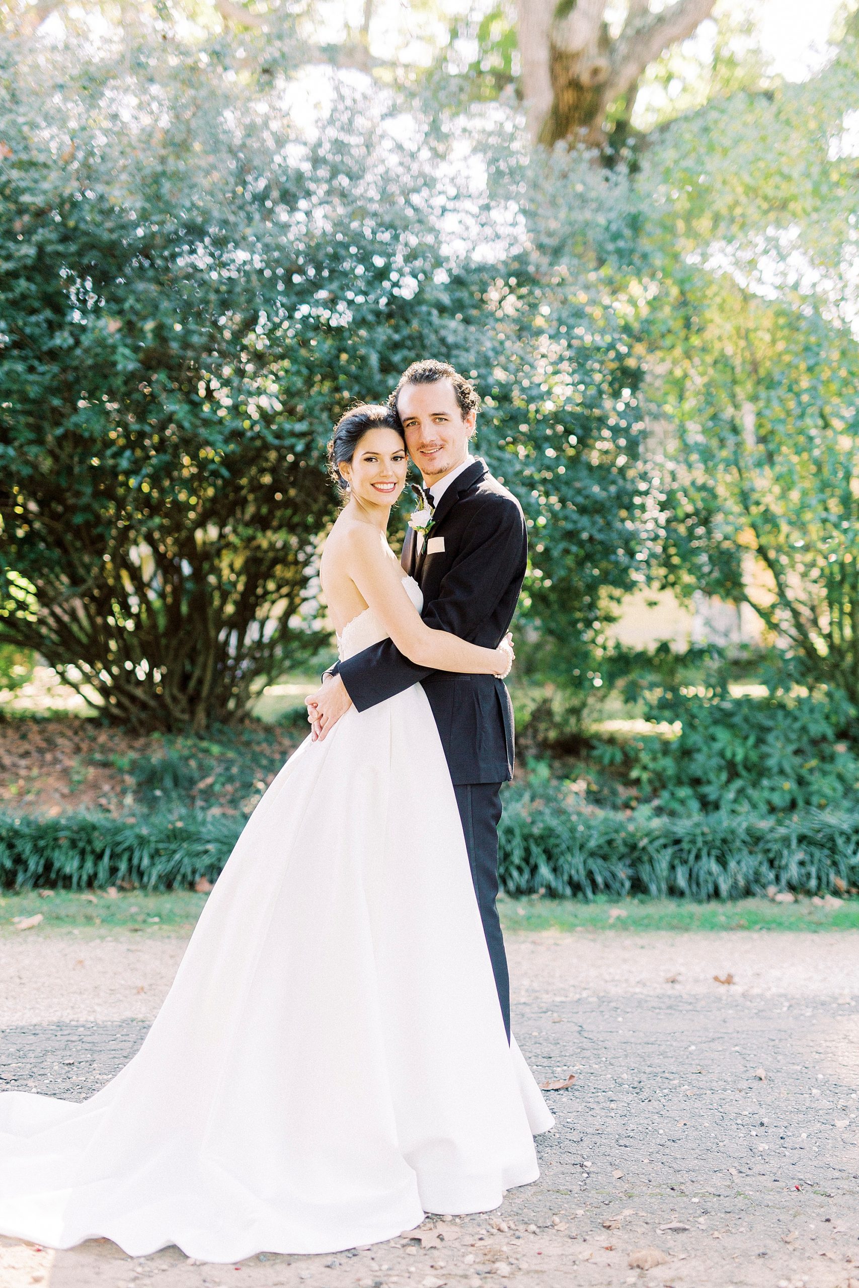 bride and groom hug during 1812 Hitching Post wedding portraits