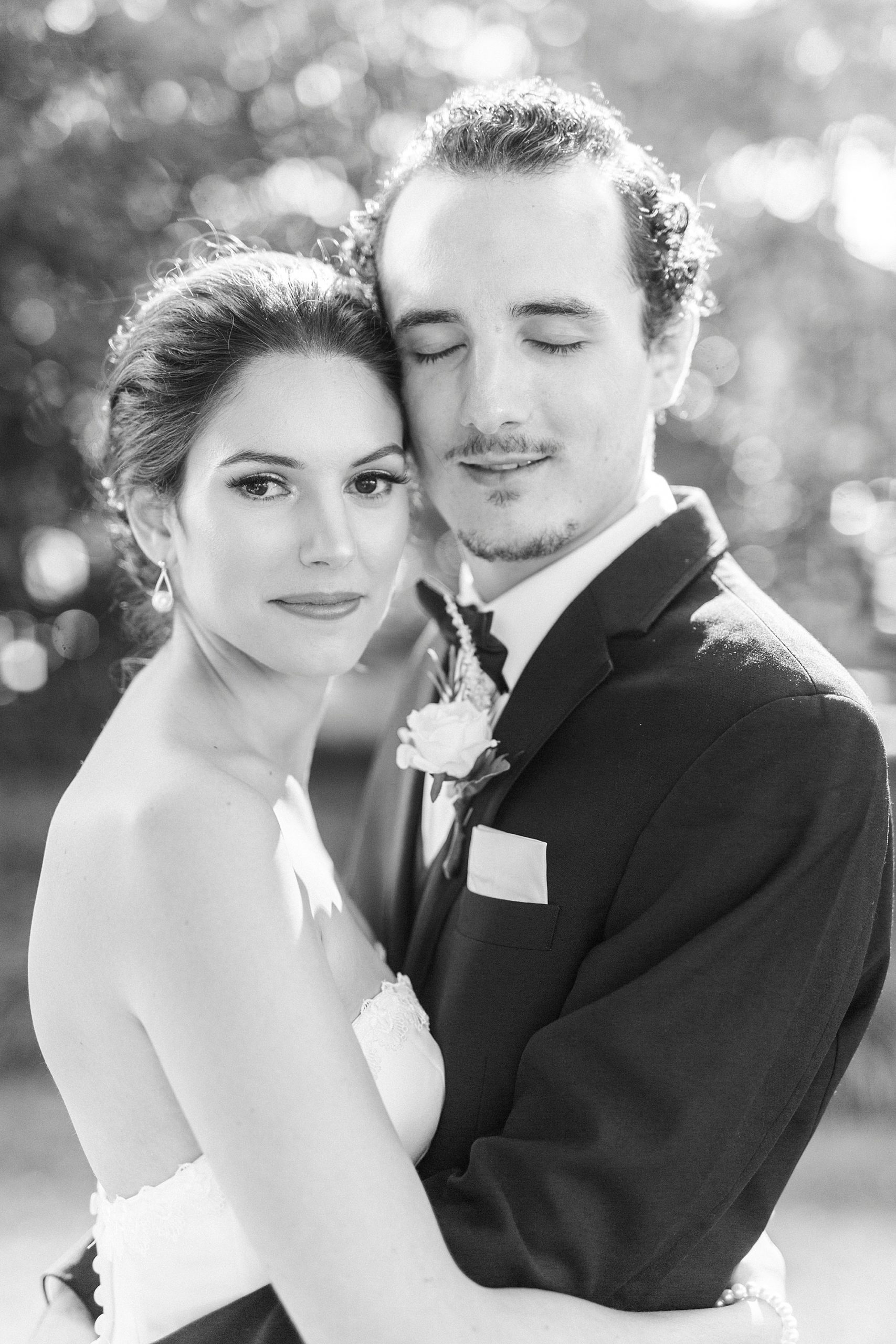 bride and groom hug with foreheads touching in North Carolina