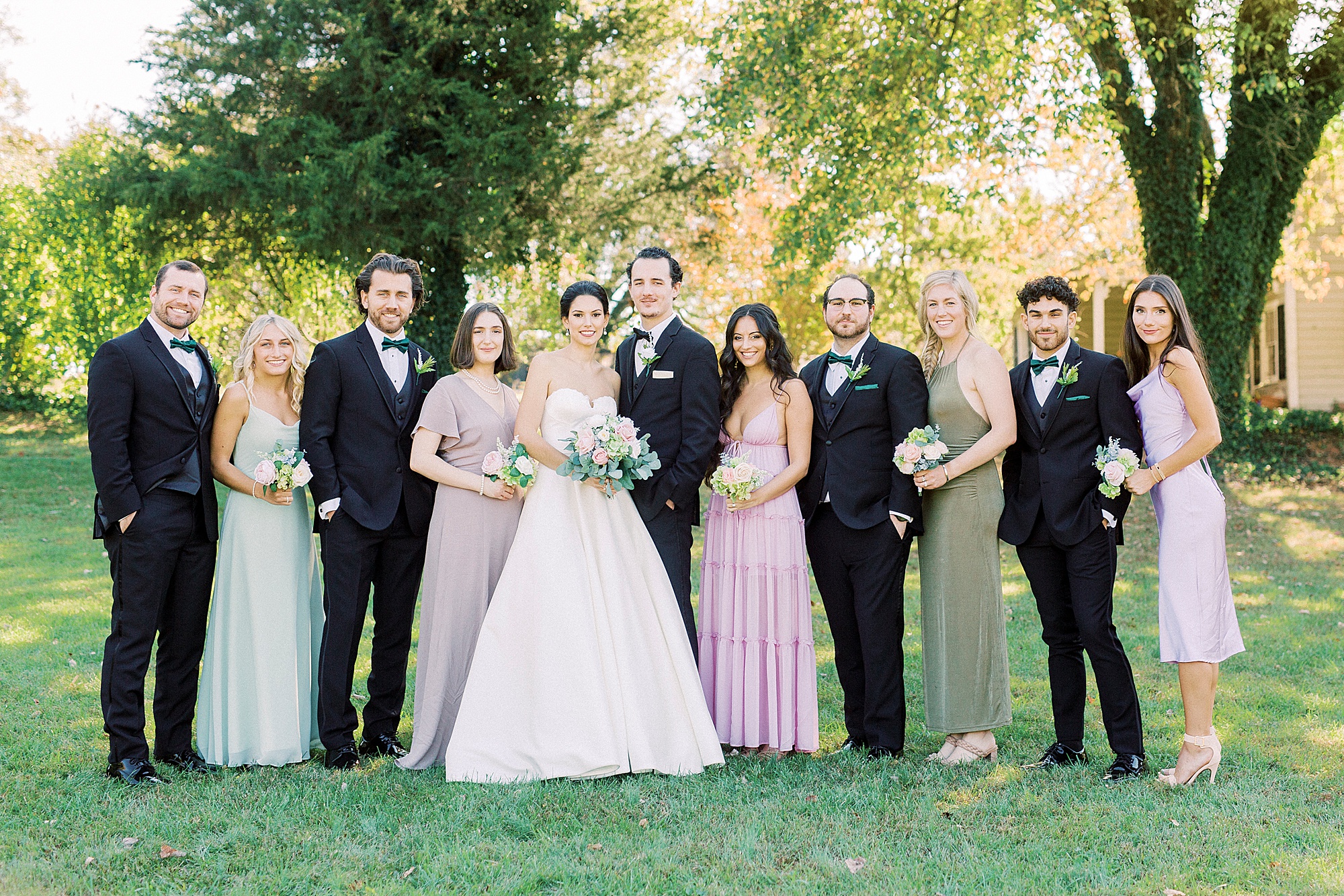 bride and groom pose with wedding party before 1812 Hitching Post wedding