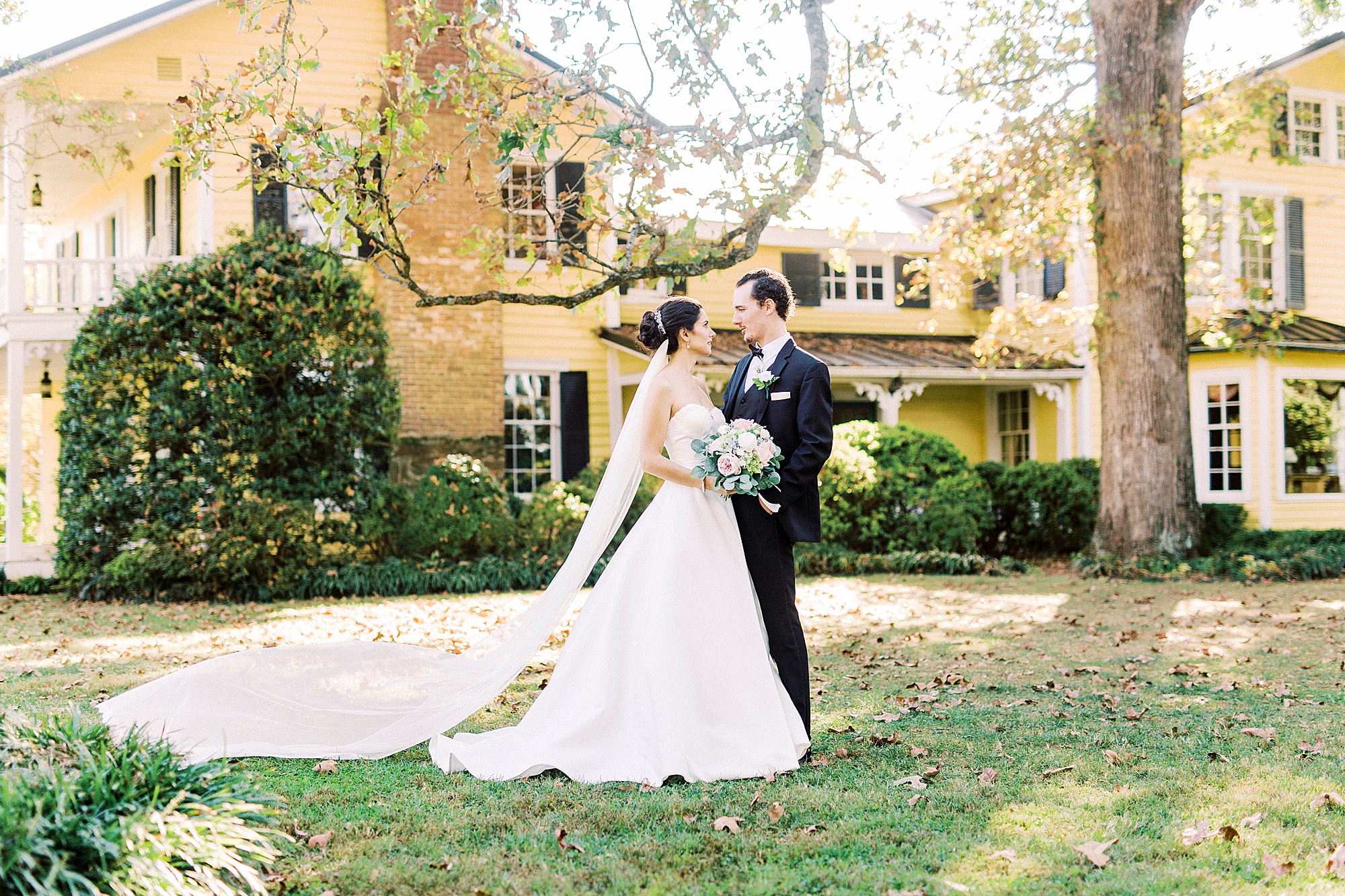 bride and groom stand outside 1812 Hitching Post
